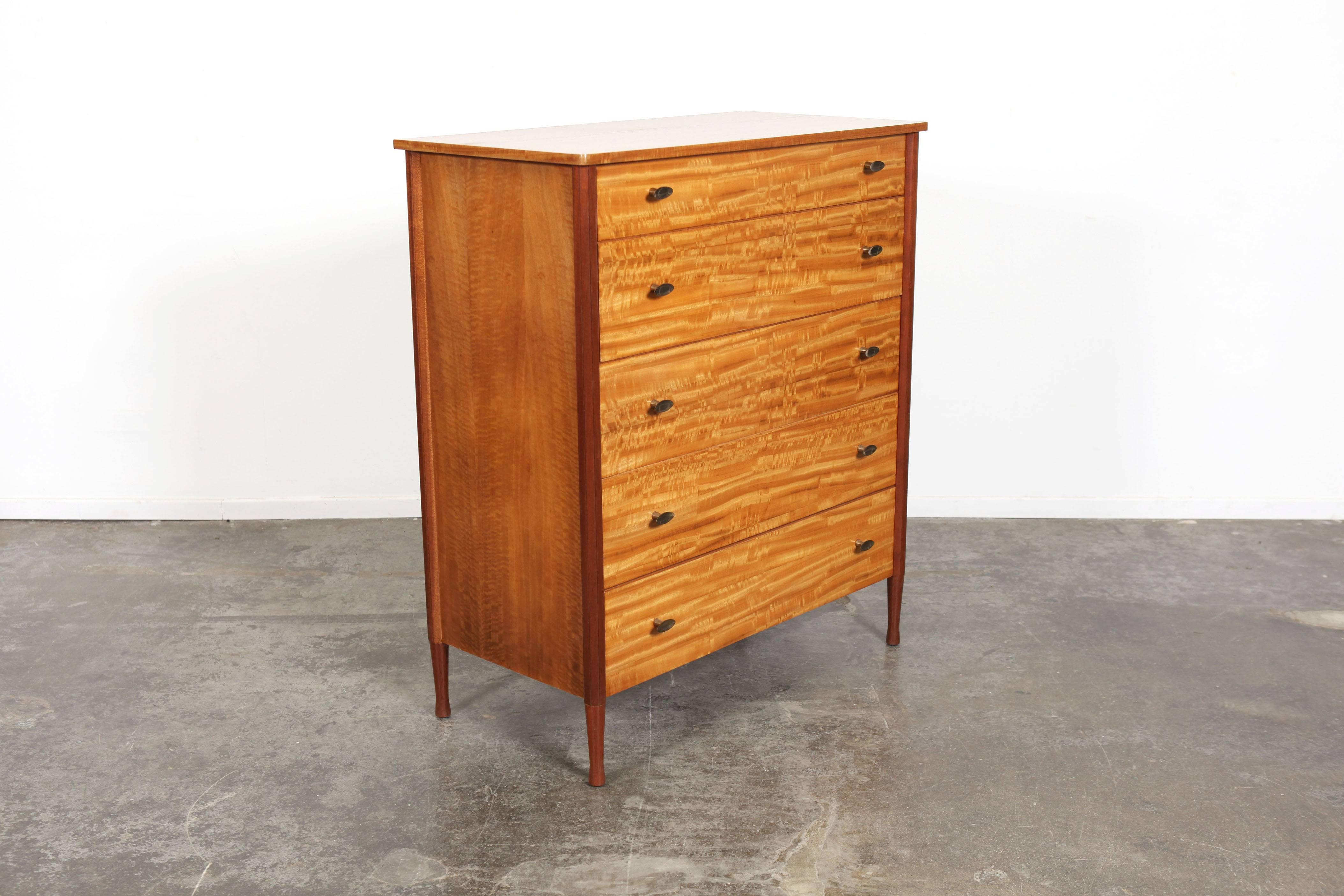 Beautiful mahogany Mid-Century Modern dresser or chest from England with sculptural brass pulls, produced by Wrighton Furniture.