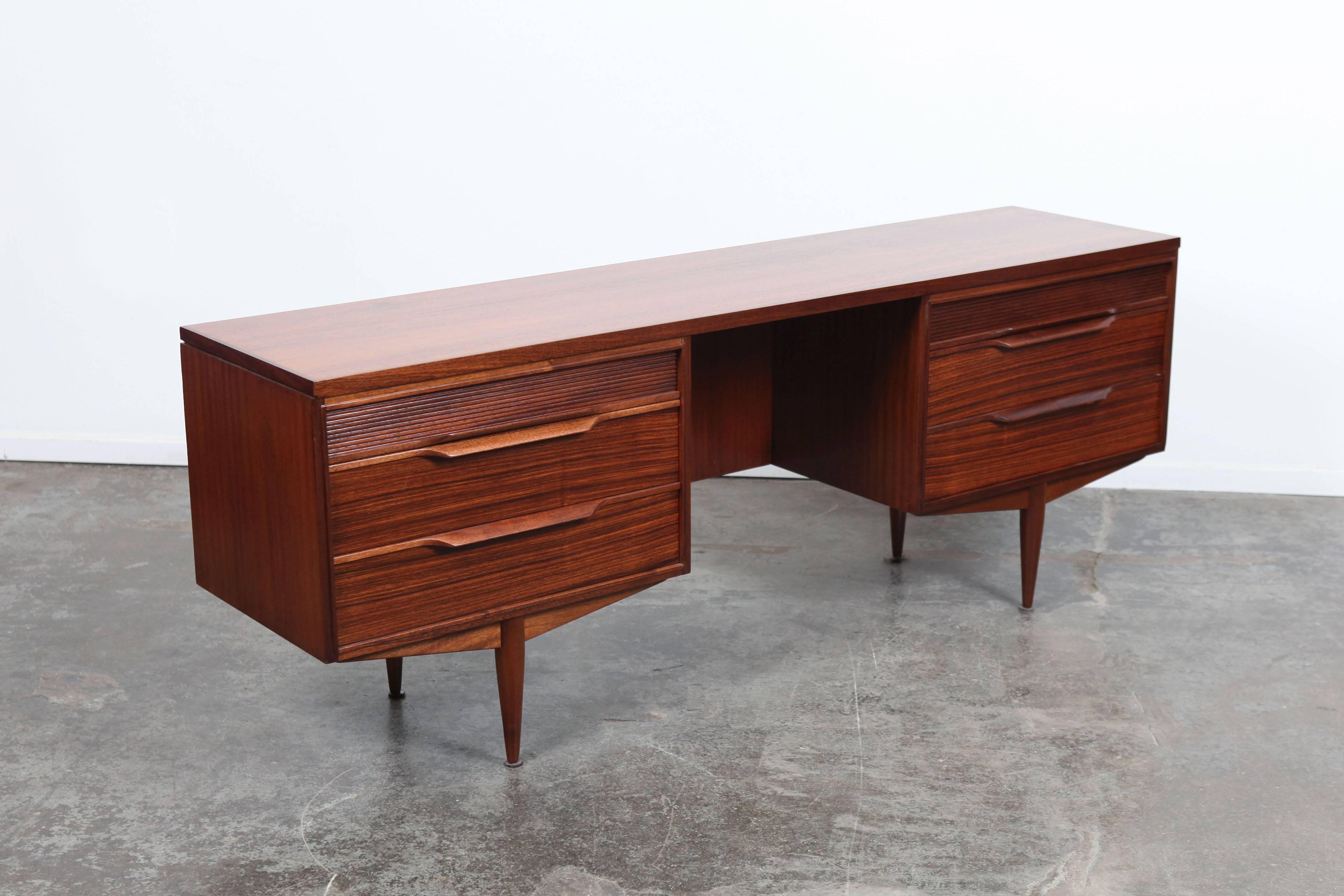 English Mid-Century Modern smaller desk-vanity made by quality manufacturer White & Newton. Newly lacquered and refinished, this piece has 6 drawers and four tapered legs.