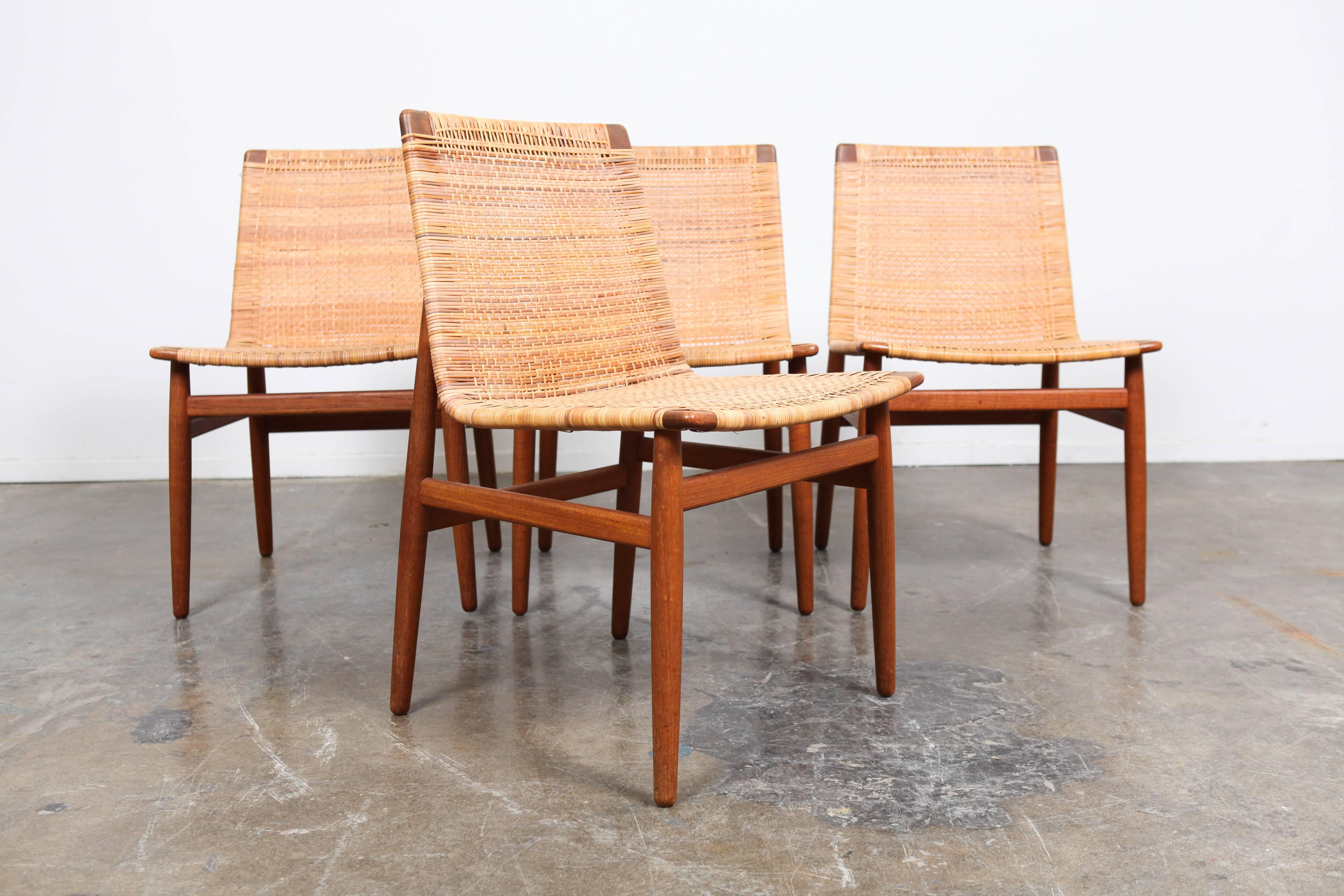 Set of four extremely rare Danish floating-seat dining chairs with original caning and teak frame designed by Jorgen Høj.