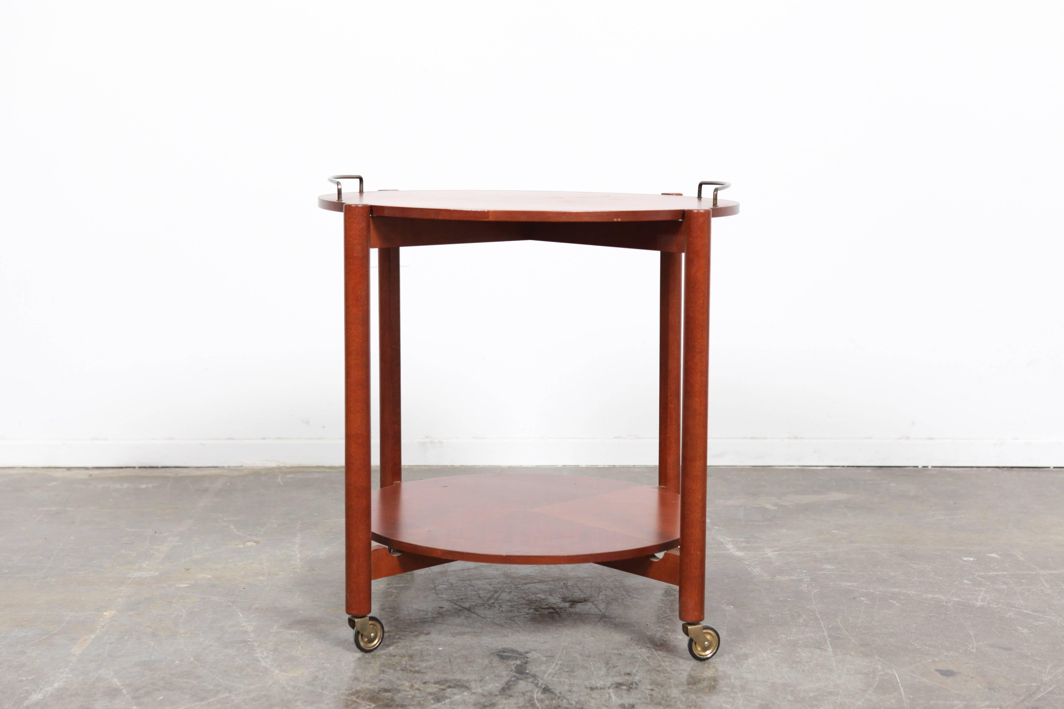 Swedish Mid-Century Modern  bi-level bar cart on casters featuring a removable drinks tray with two metal rails. Both circular surfaces feature beautiful segmented veneer.