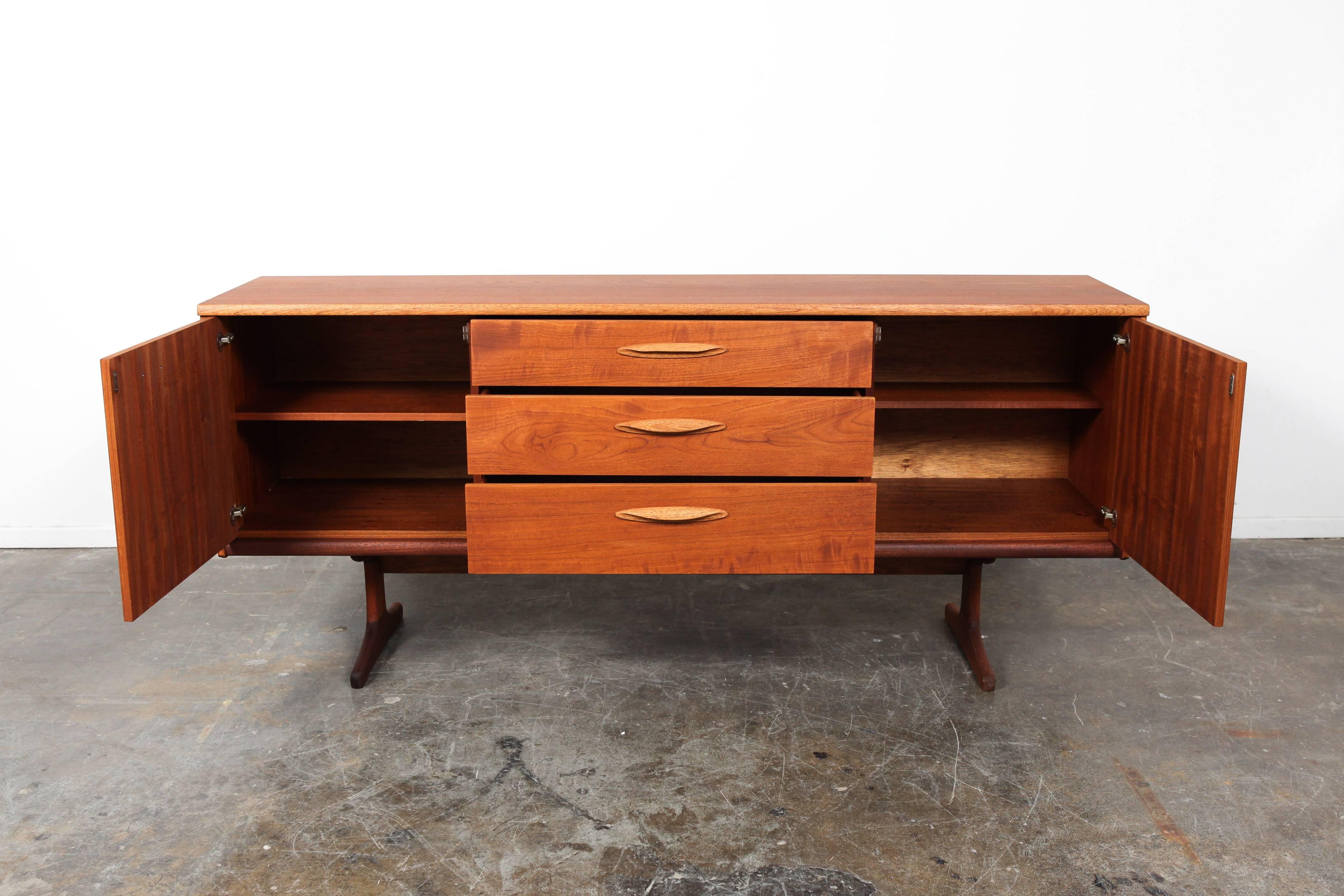 English Mid-Century Modern three-drawer, two-door teak sideboard or vanity designed by Frank Guille for Austinsuite.