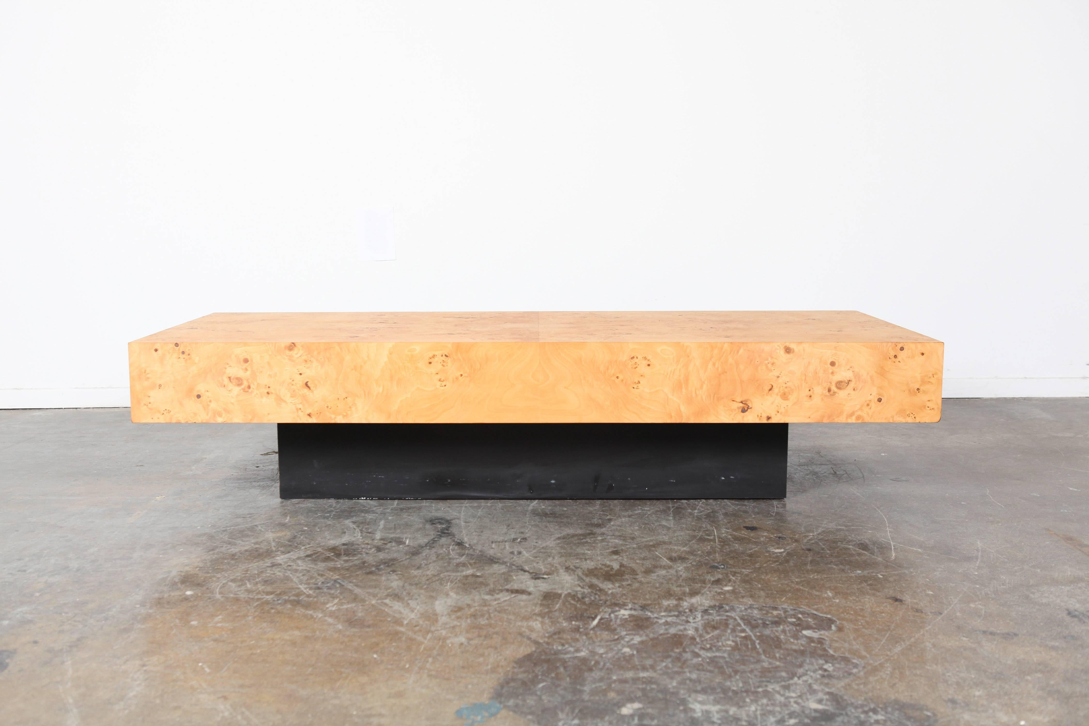 Beautiful burl olive wood coffee table designed by Milo Baughman, circa 1960s. This piece is in incredible condition and rests on a plinth base.