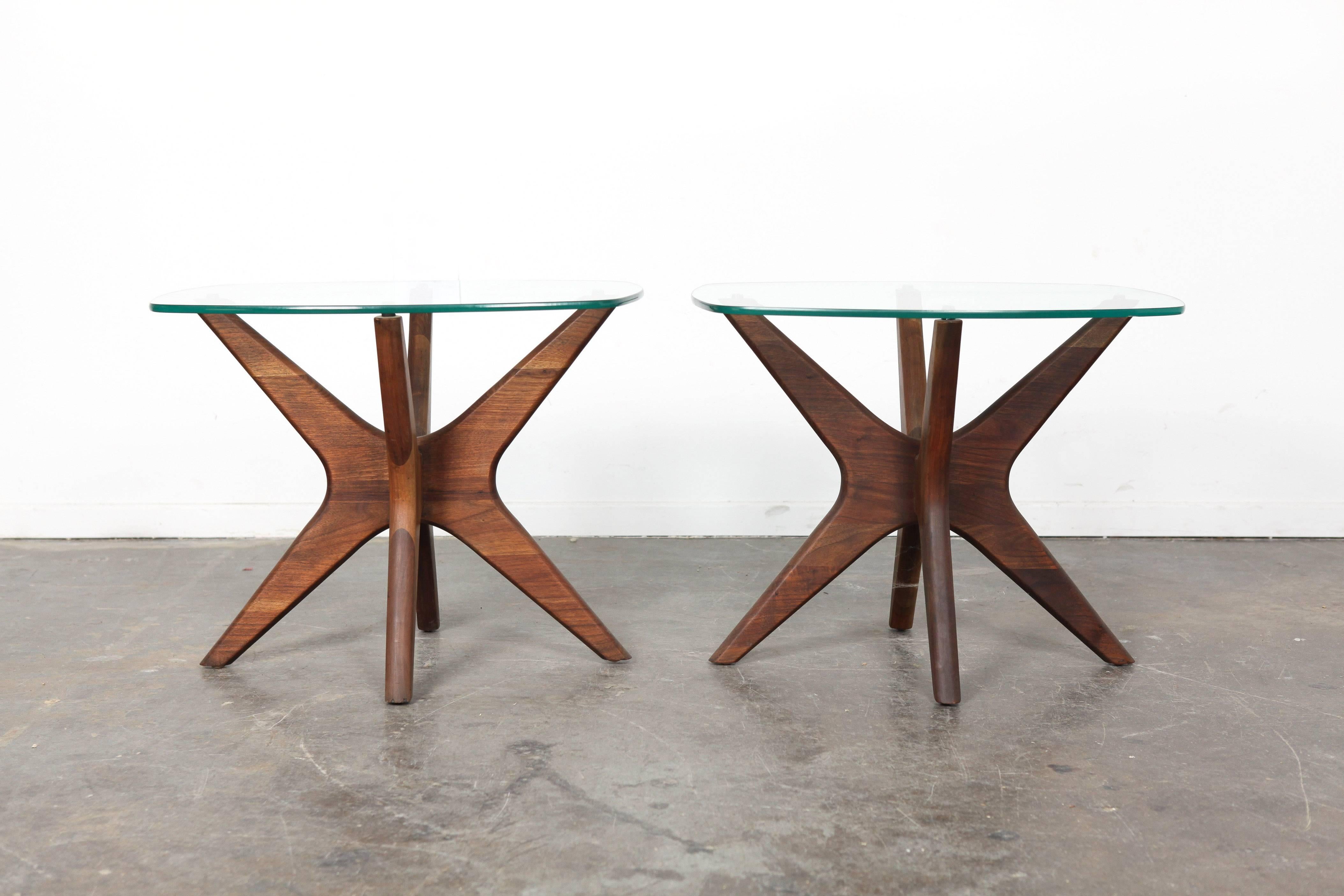 Matching pair of American Mid-Century end tables designed by Adrian Pearsall for Craft Associates. These tables are supported by sculptural walnut bases and rounded rectangle glass tops.