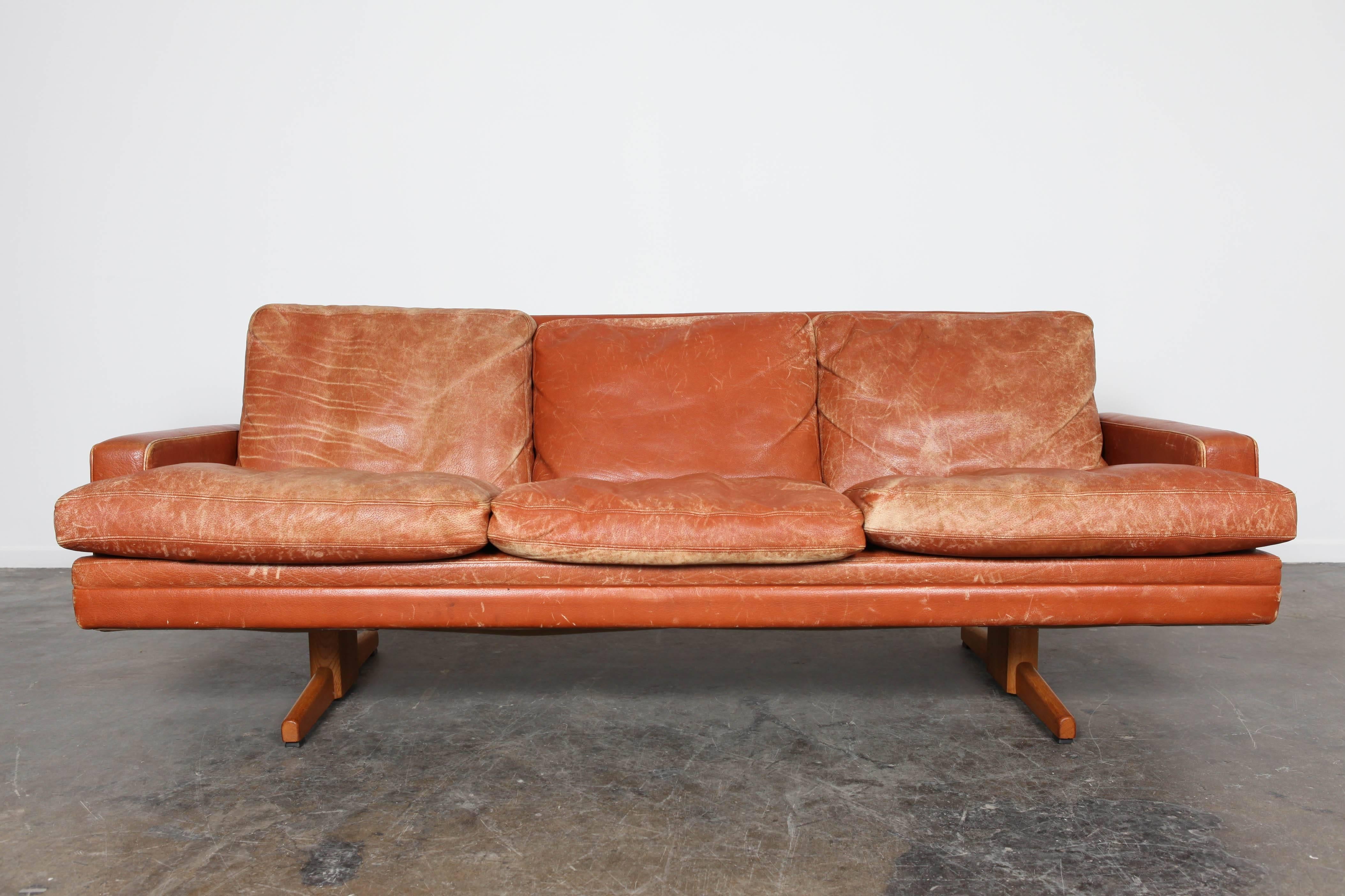 Norwegian Mid-Century Modern burnt-orange leather sofa on oak base by Fredrik Kayser.