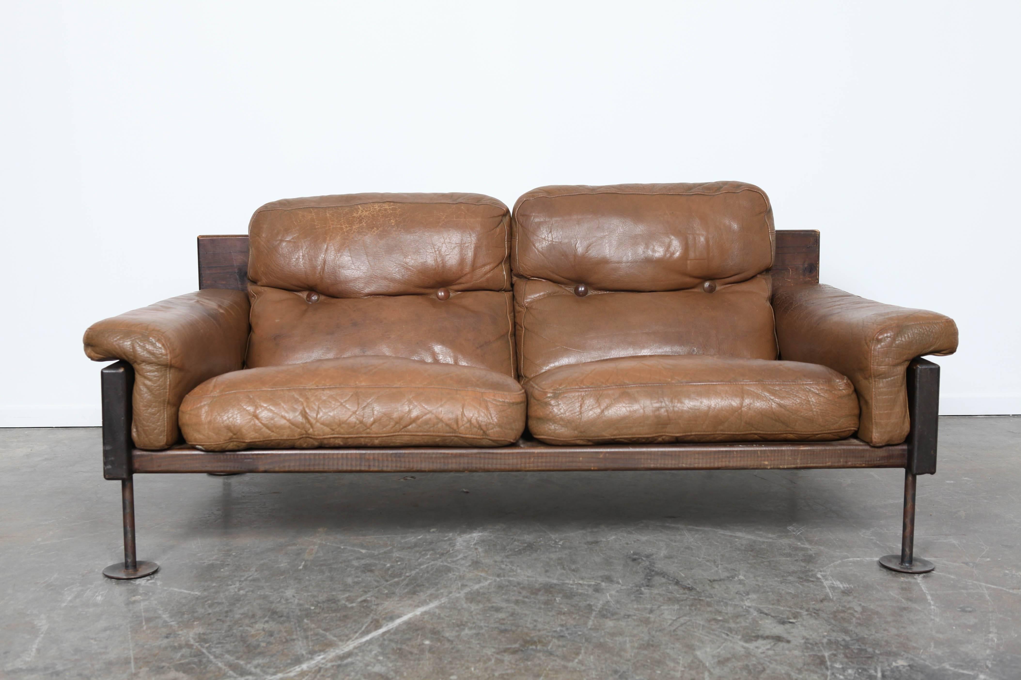 Brown leather two-seat sofa by Hannu Jyräs, Finland. Pine frame, and metal legs. Measures: Arm height 17 inches.



 