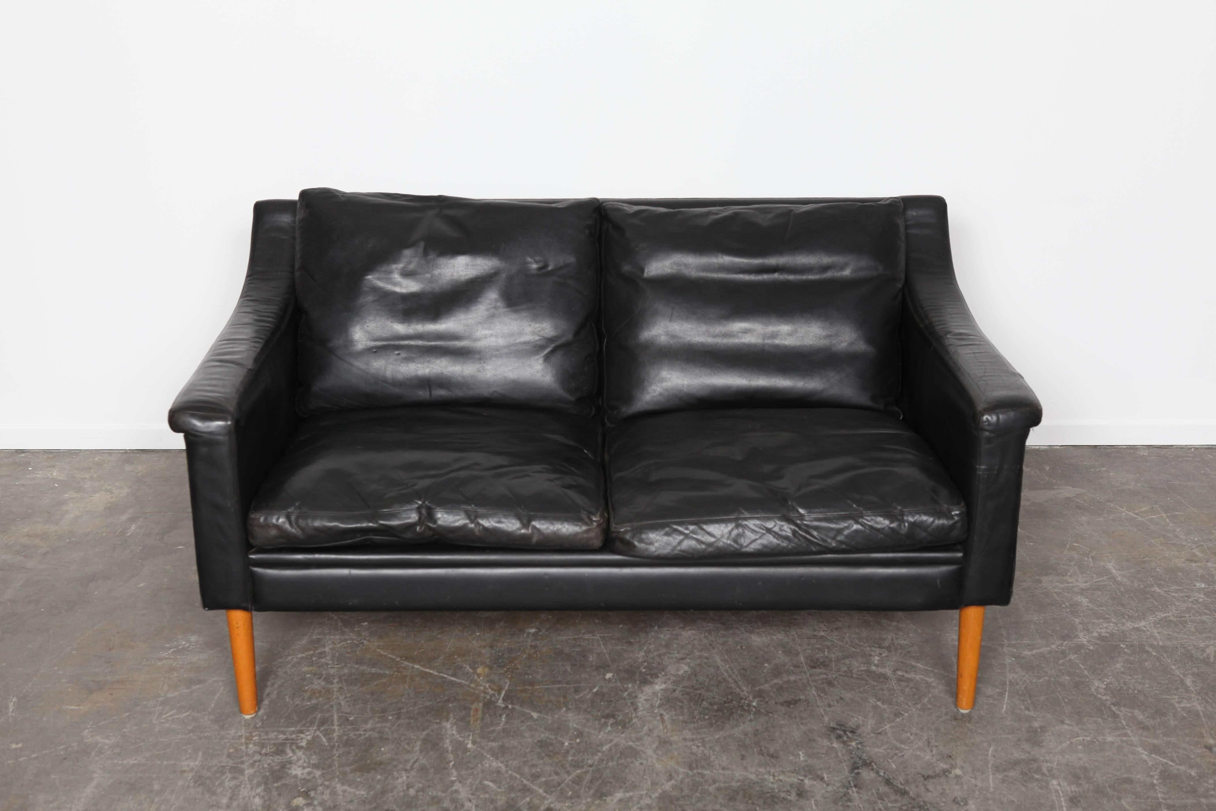 Black leather, two-seat sofa.