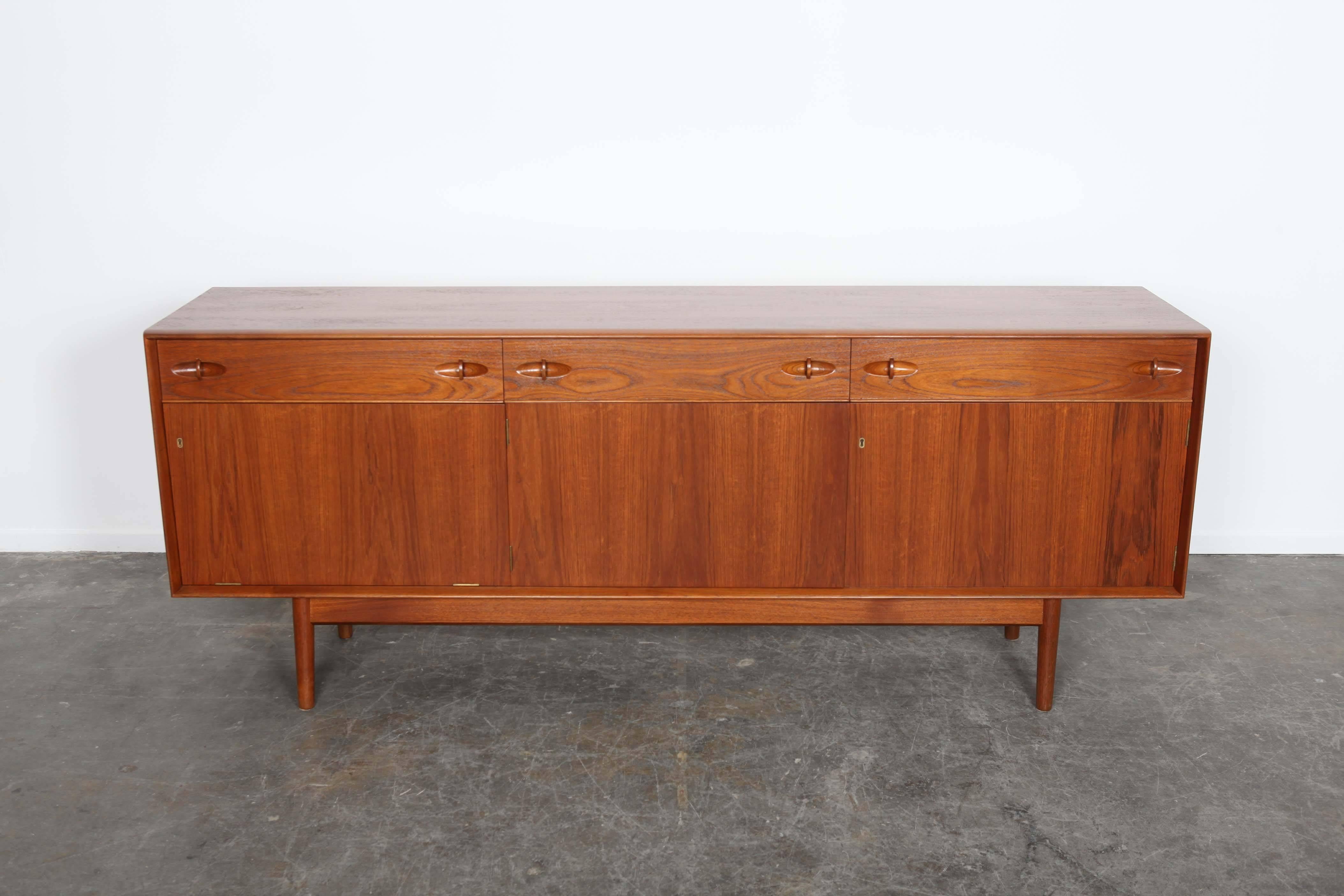 Four-drawer, teak sideboard made by the small, family-owned Dalescraft Furniture Co. of Yorkshire, England.
