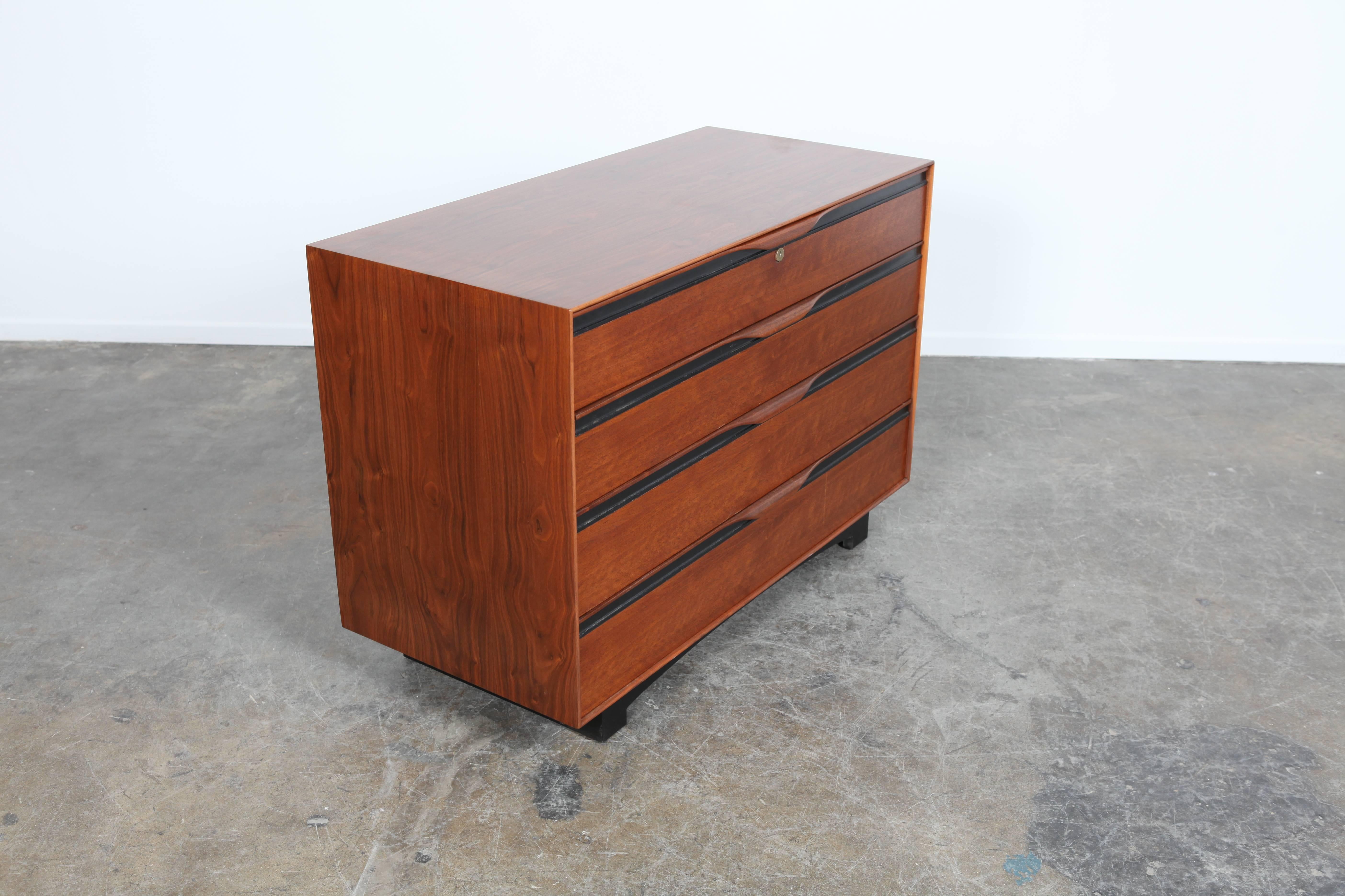 Walnut four-drawer dresser with black accents, American made, designed by John Kapel for Glenn of California.