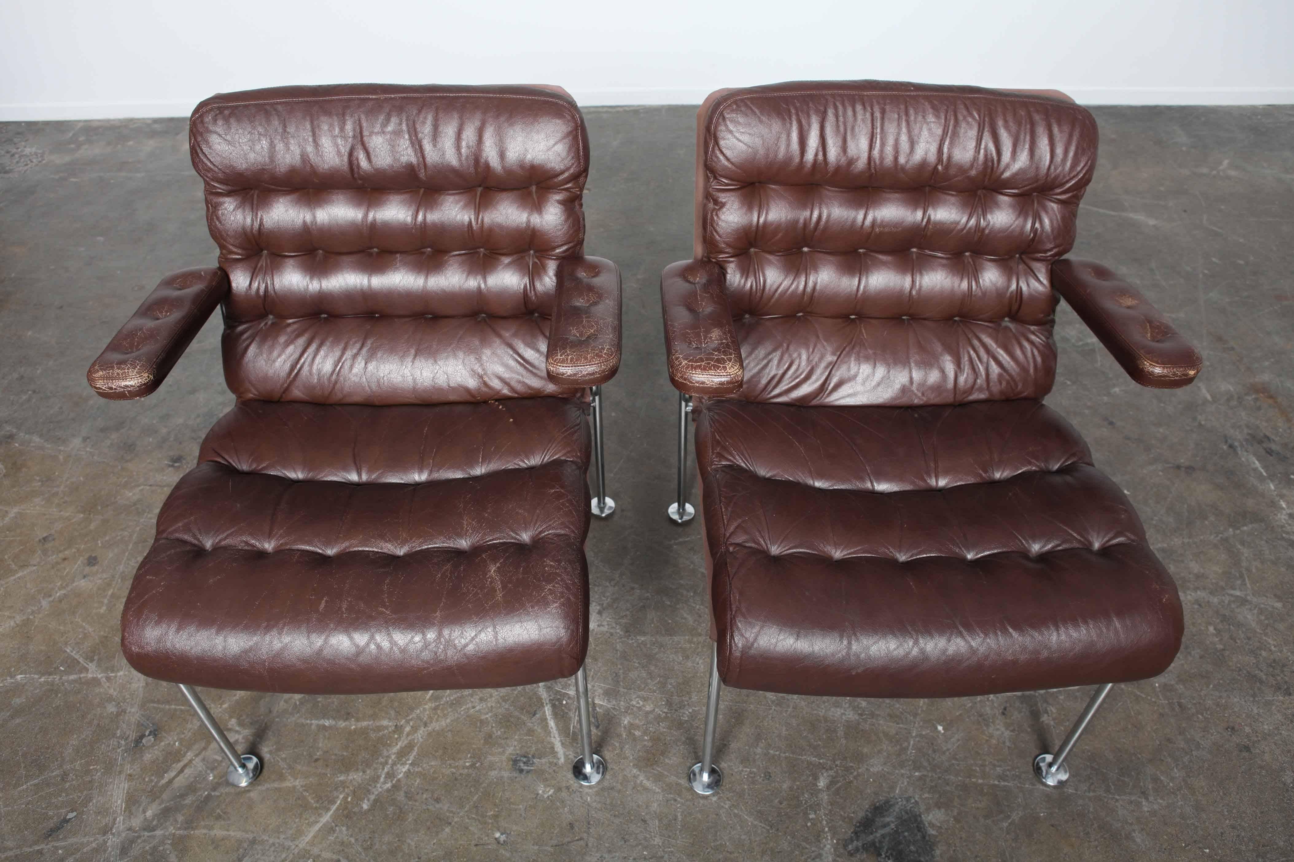 Pair of brown tufted original leather and metal framed chairs designed by Bruno Mathsson for DUX, model 