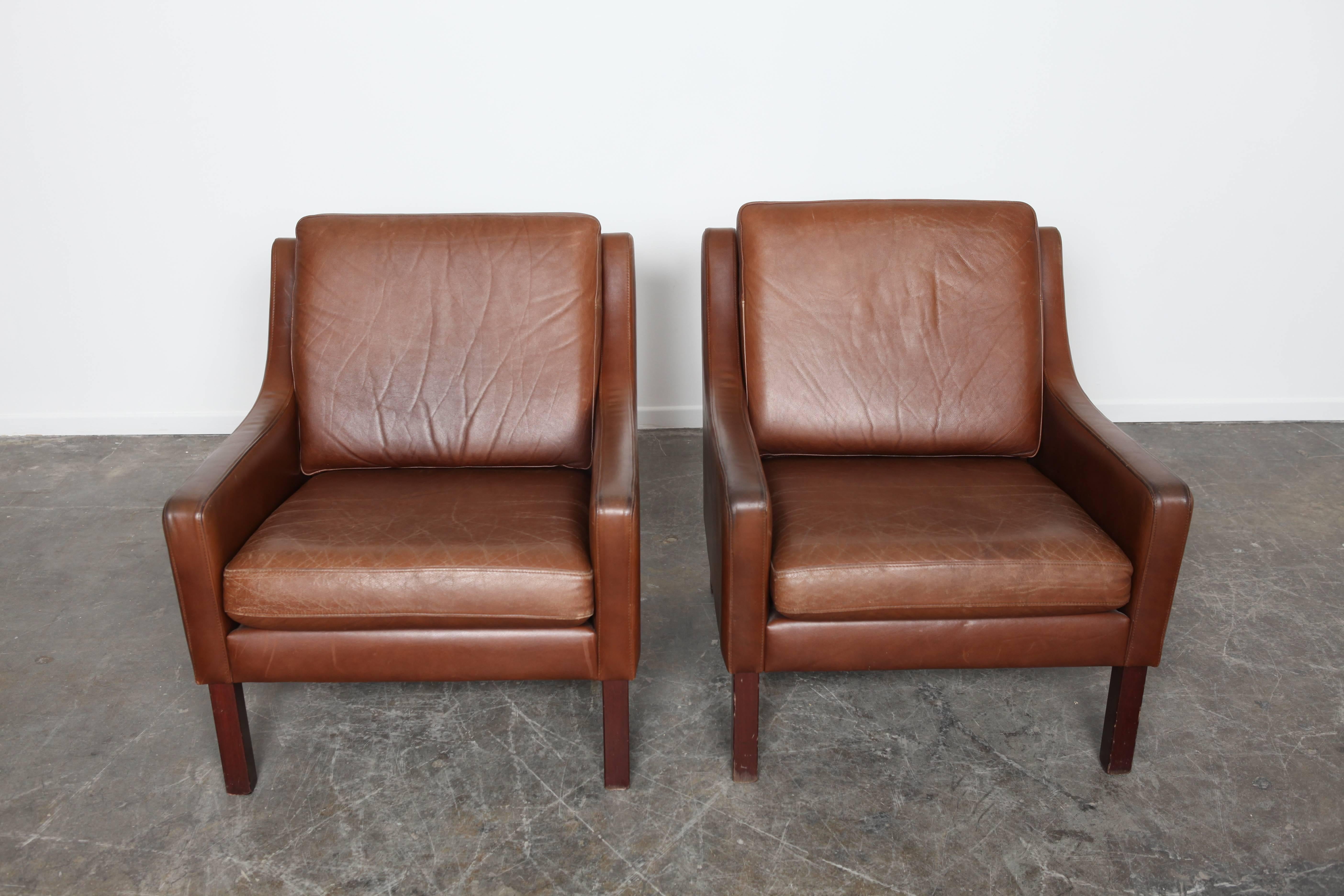 Pair of Mid-Century Modern, brown leather lounge chairs from Sweden. Original leather. Great natural wear and patina.