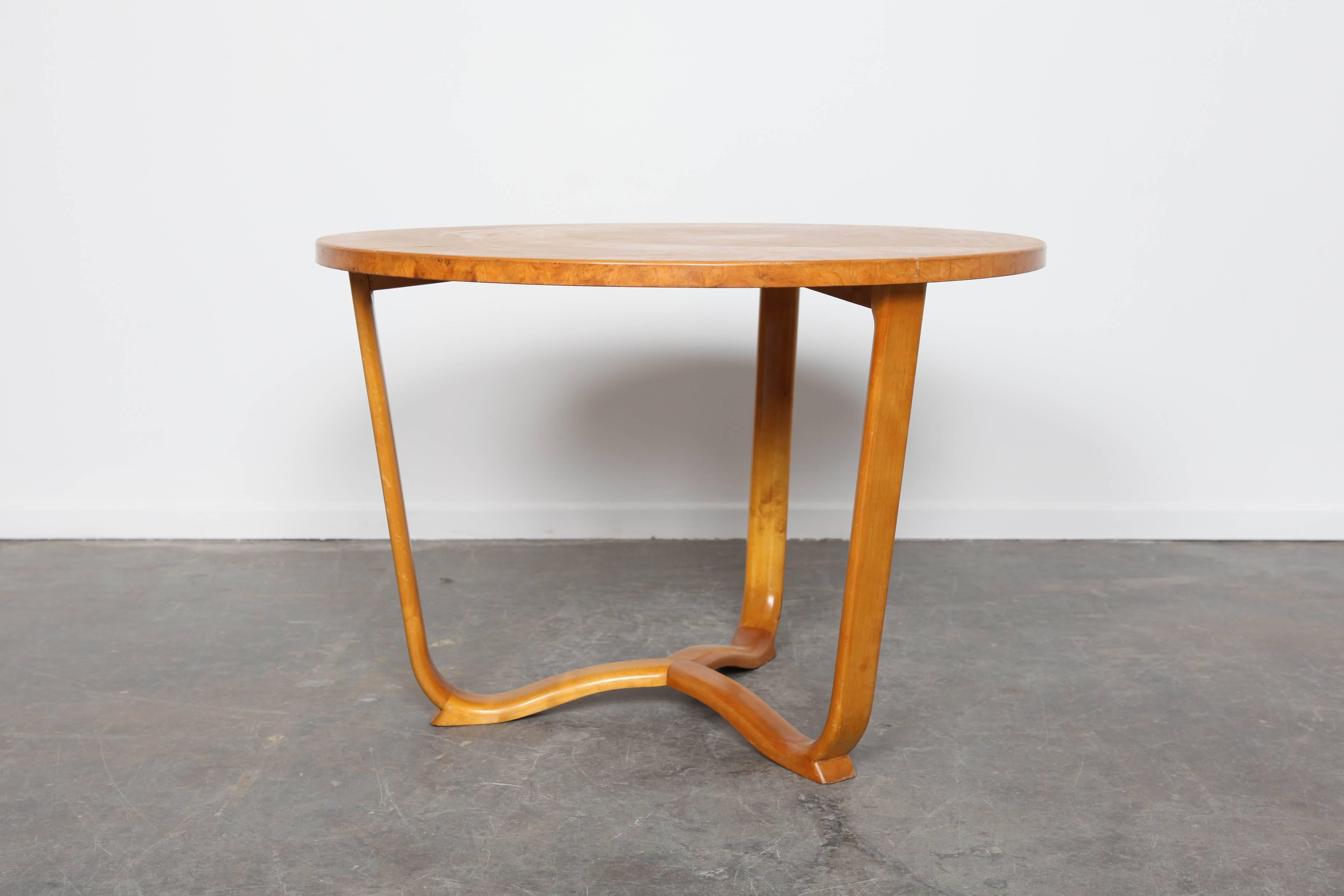 Burl wood coffee table, with veneers laid in pie shape. Three legs bent.