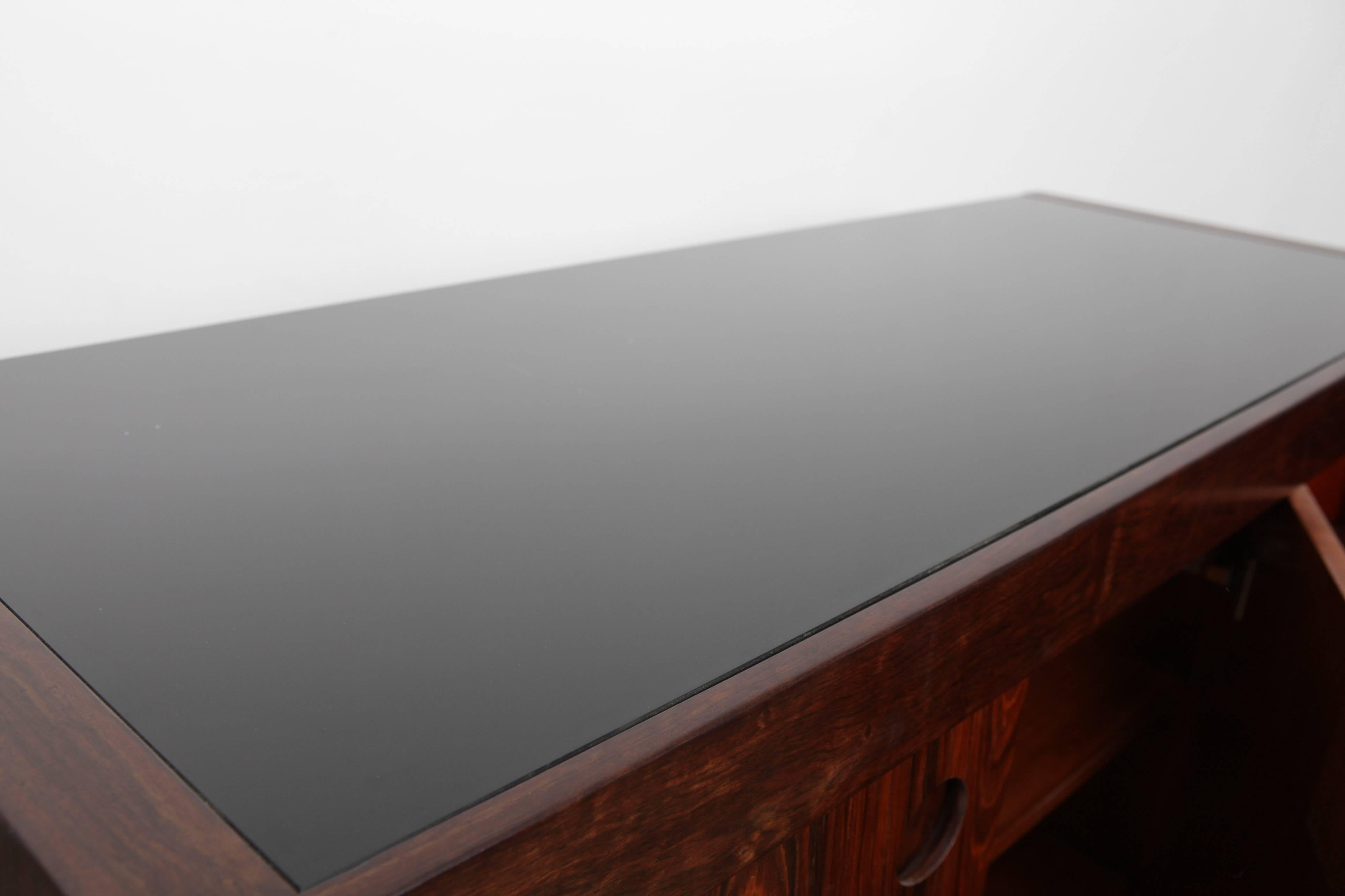A beautiful three-door rosewood credenza with brass hardware, designed by Sergio Rodrigues, Brazil, 1960s.