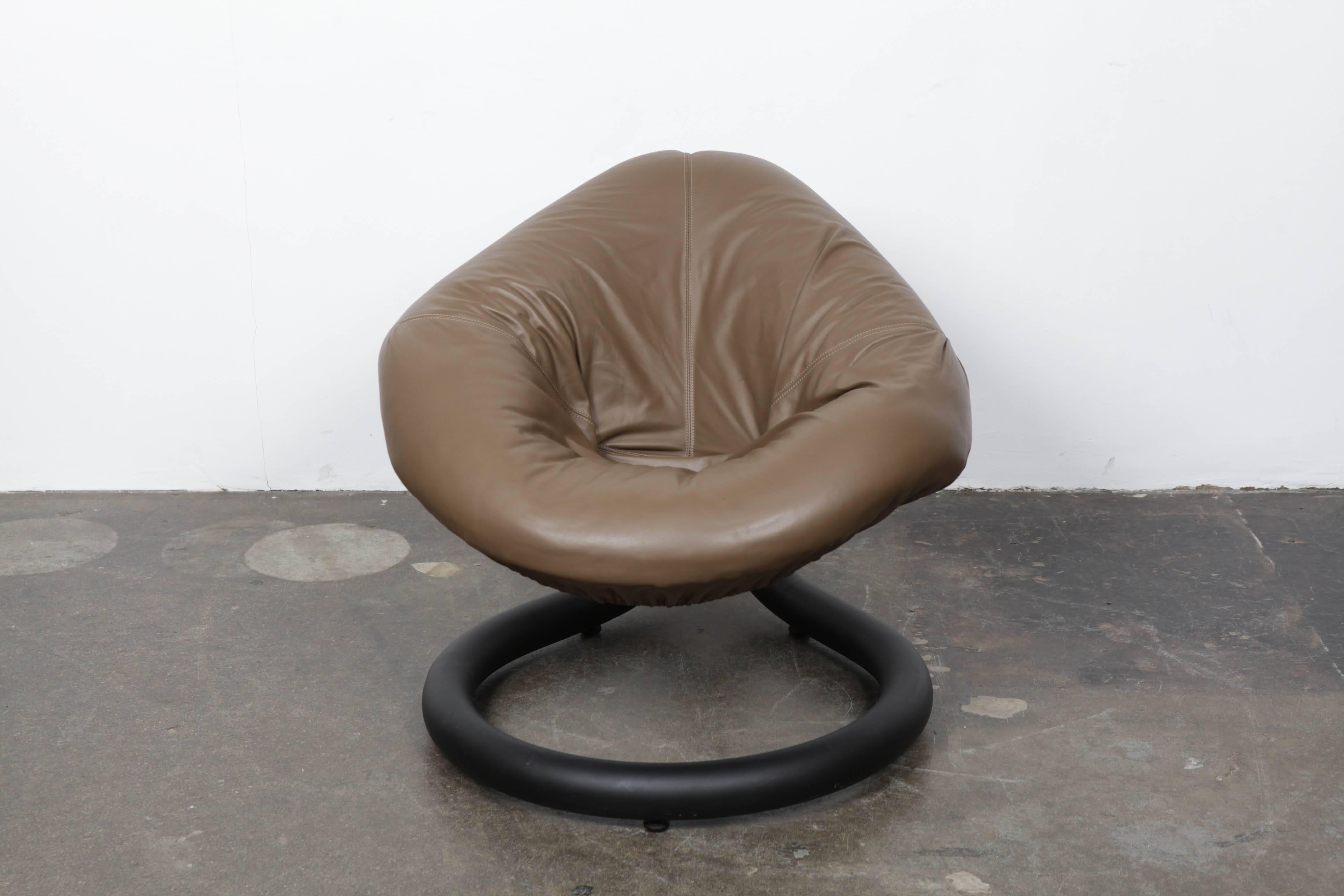 A unique single chair by an unknown Brazilian designer. The chair has an iron base that has springs to it adding a bounce to the seat. The seat is upholstered in leather and is shaped like a tear drop.