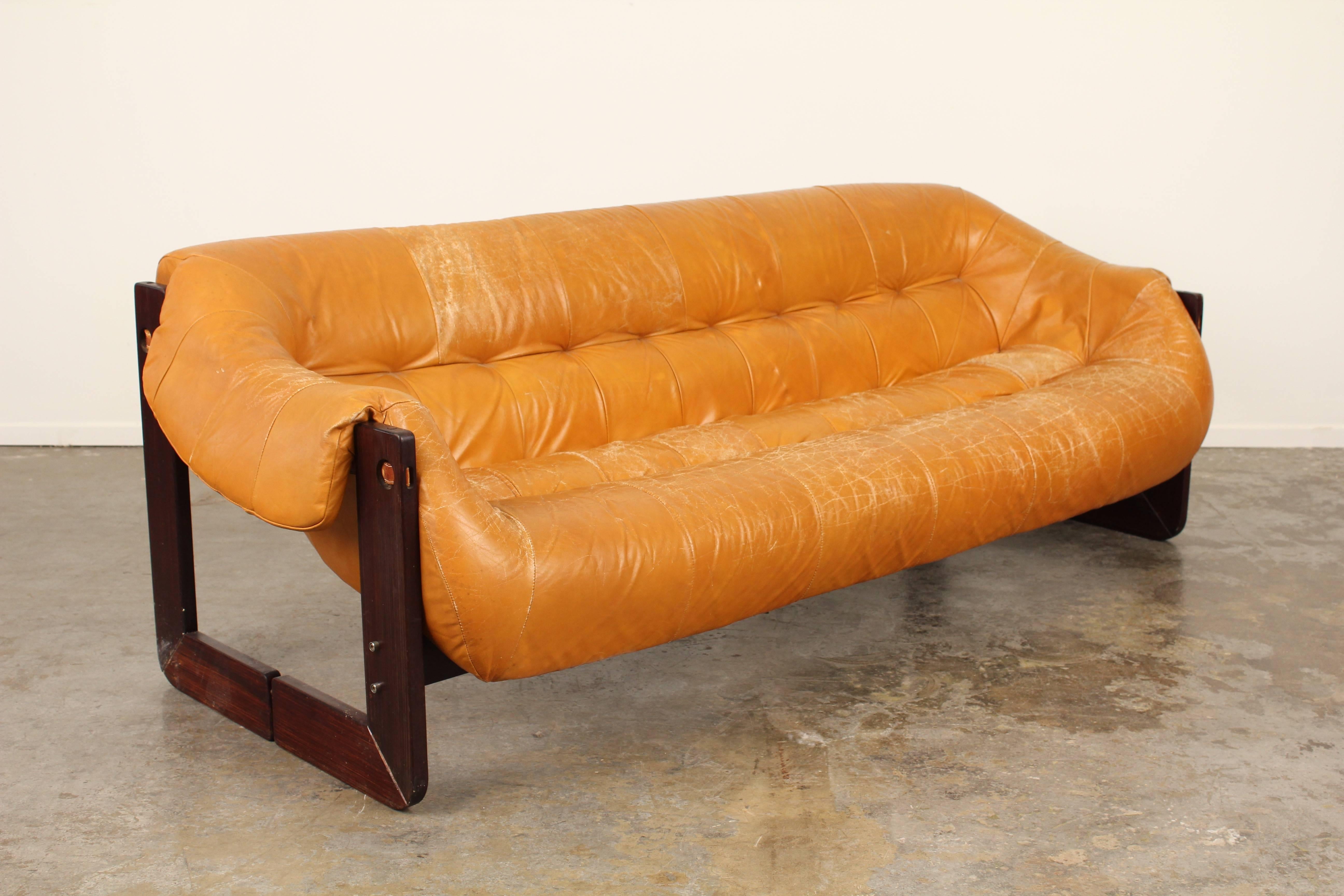 Fantastic vintage sofa by Percival Lafer. Brazilian rosewood and original vintage camel colored leather with fantastic patina. Really unique design and construction make this a true statement piece. Matching lounge chair also available.