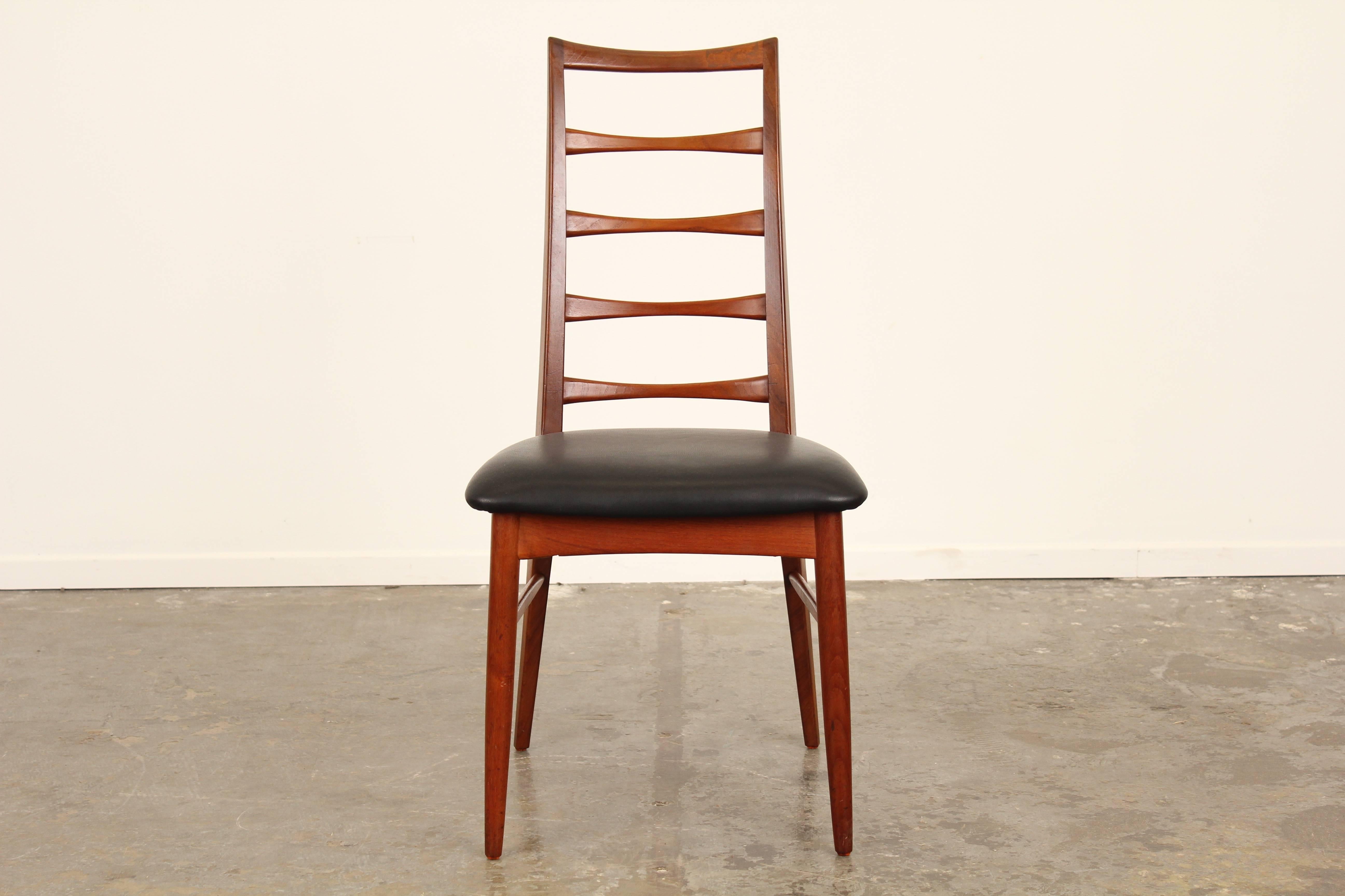 Fantastic set of 6 teak dining chairs by Niels Kofoed.  Tall ladder back and reupholstered seats in black leather.  Newly refinished.  An additional set of 6 is available.