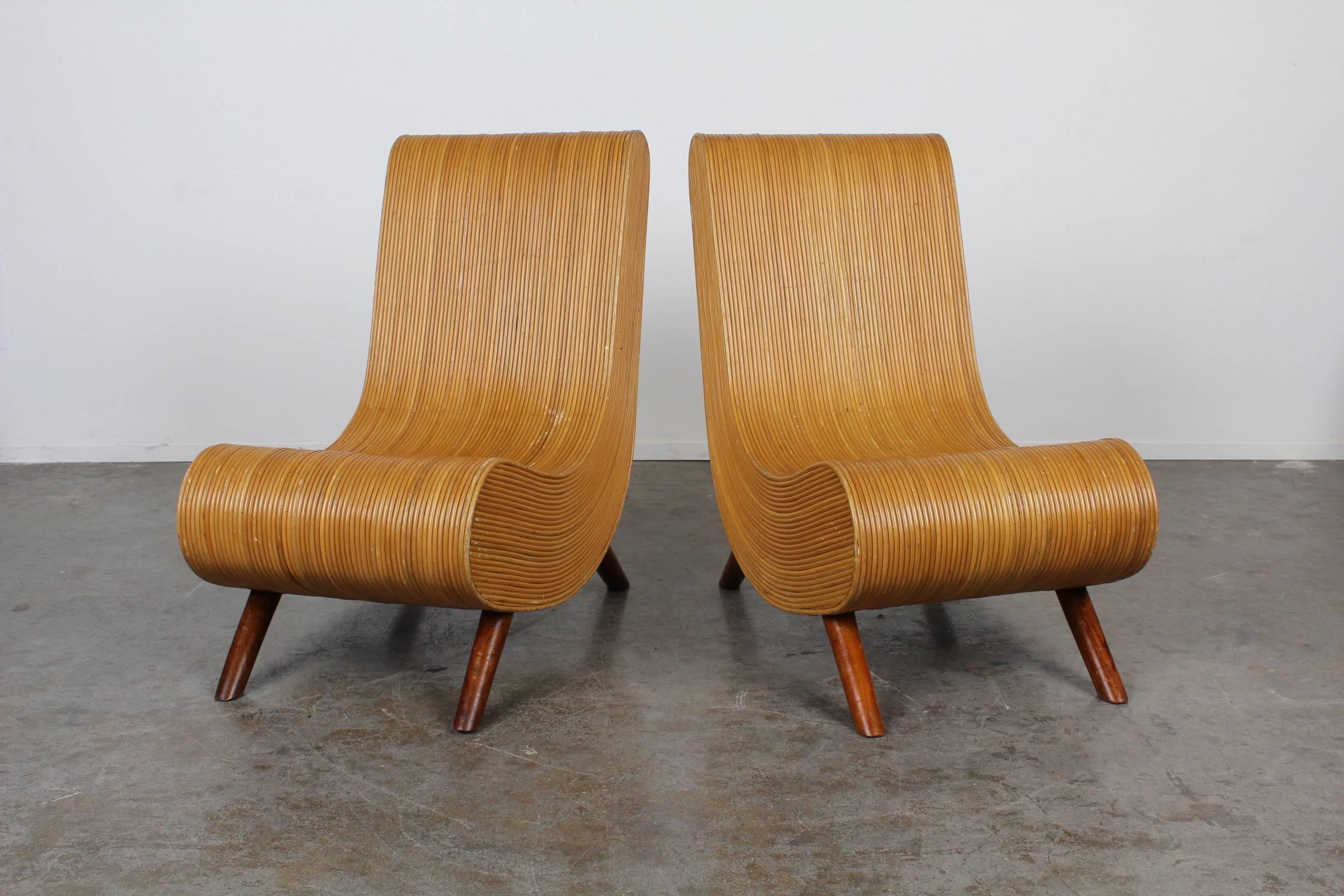Very unique and rare pair of slipper style Mid-Century Modern bamboo low sitting chairs with four wooden legs. Unsure of any maker/designer/origin country.