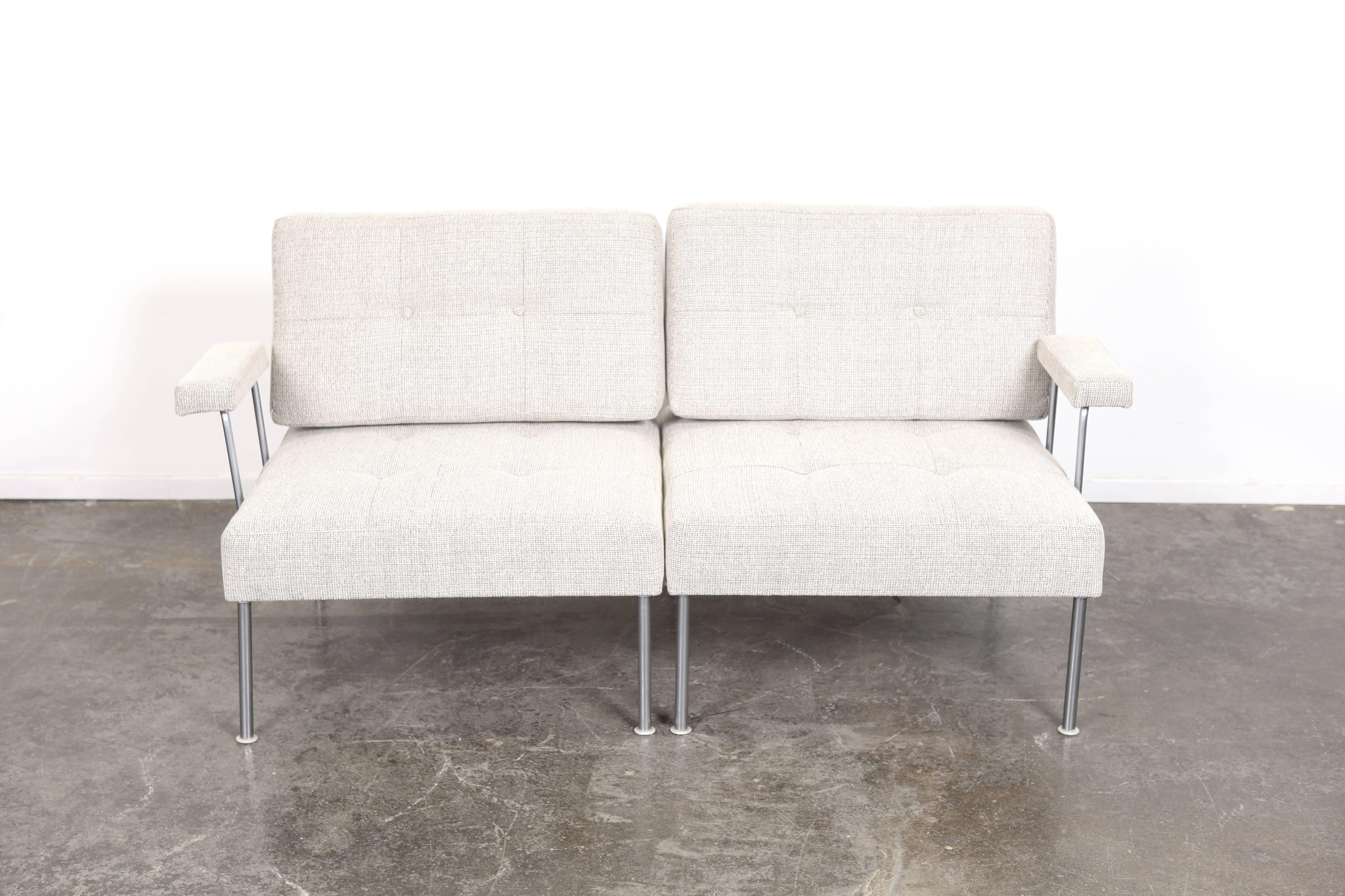 Danish Mid-Century Modern modular steel frame 'Revolt' sectional sofa by Poul Cadovius. Newly upholstered in a combination of cement and off-white contrasted with a dark grey weave.