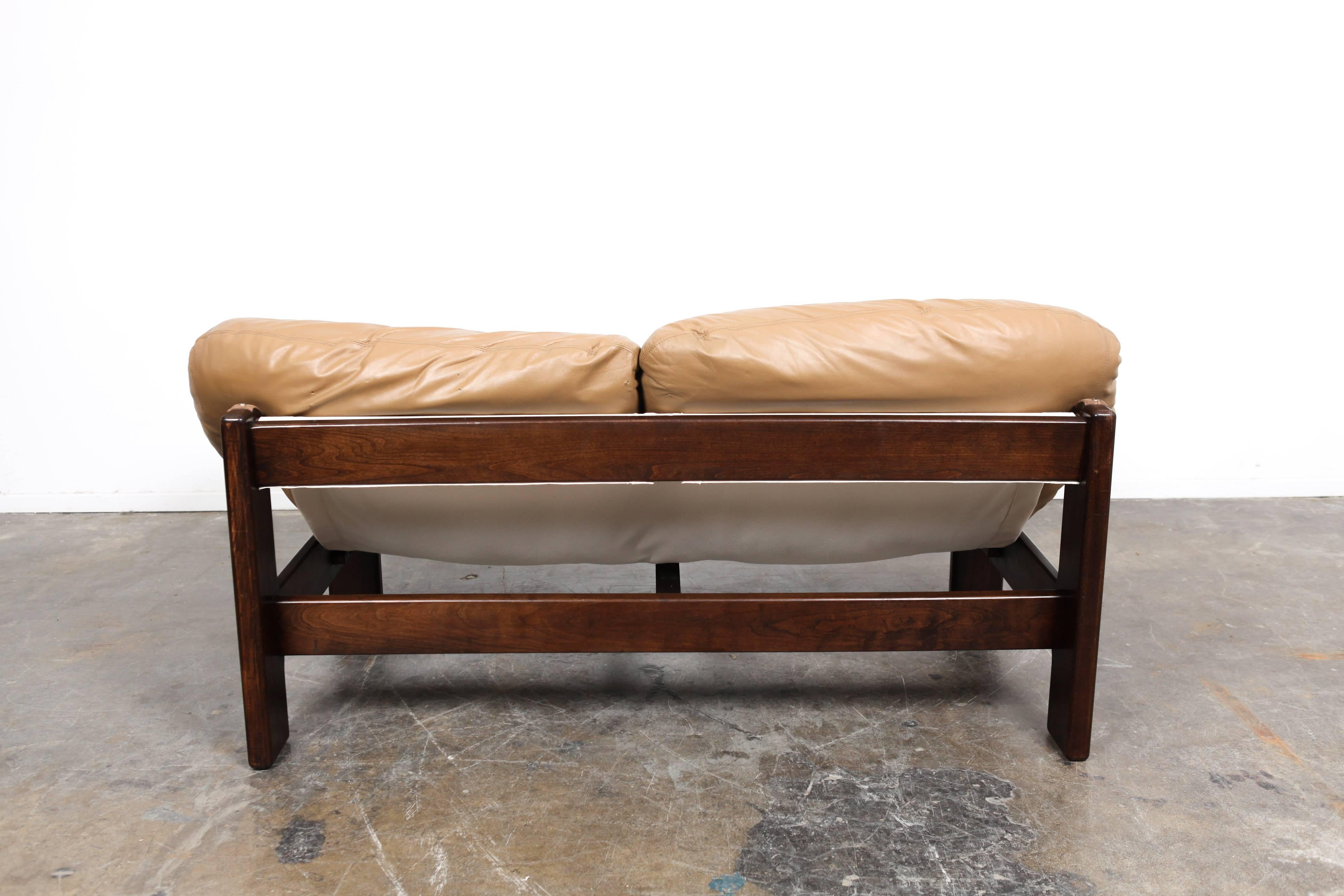 Incredible 1970s Dutch leather sofa designed by Gerard Van Den Berg. Two large cushions are supported by a canvas sling and a structural wooden frame. This piece appears to be influenced by similar Brazilian Mid-Century modern designs.