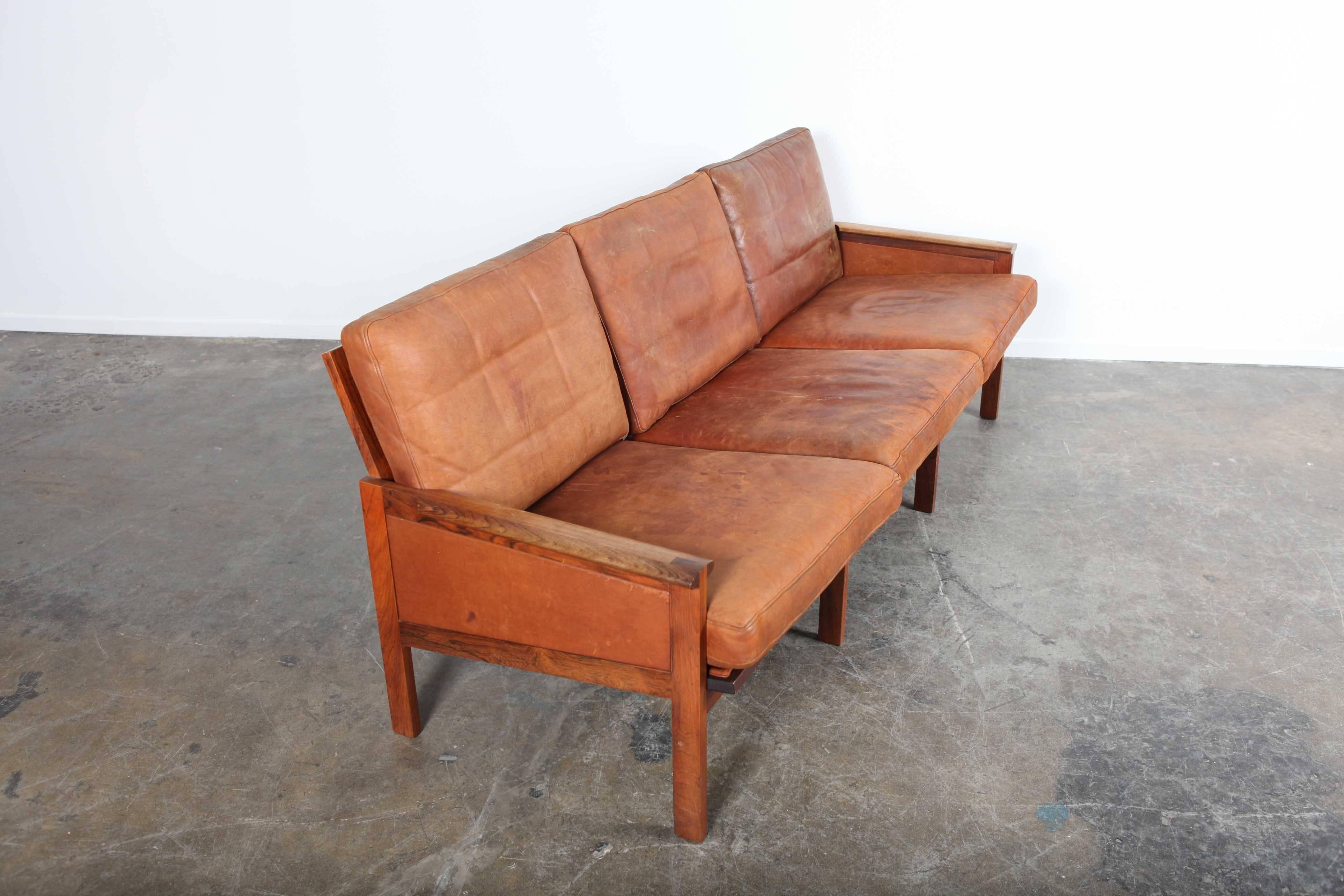 Danish leather sofa with solid rosewood frame by Illum Wikkelso for Niels Eilersen. Original leather.