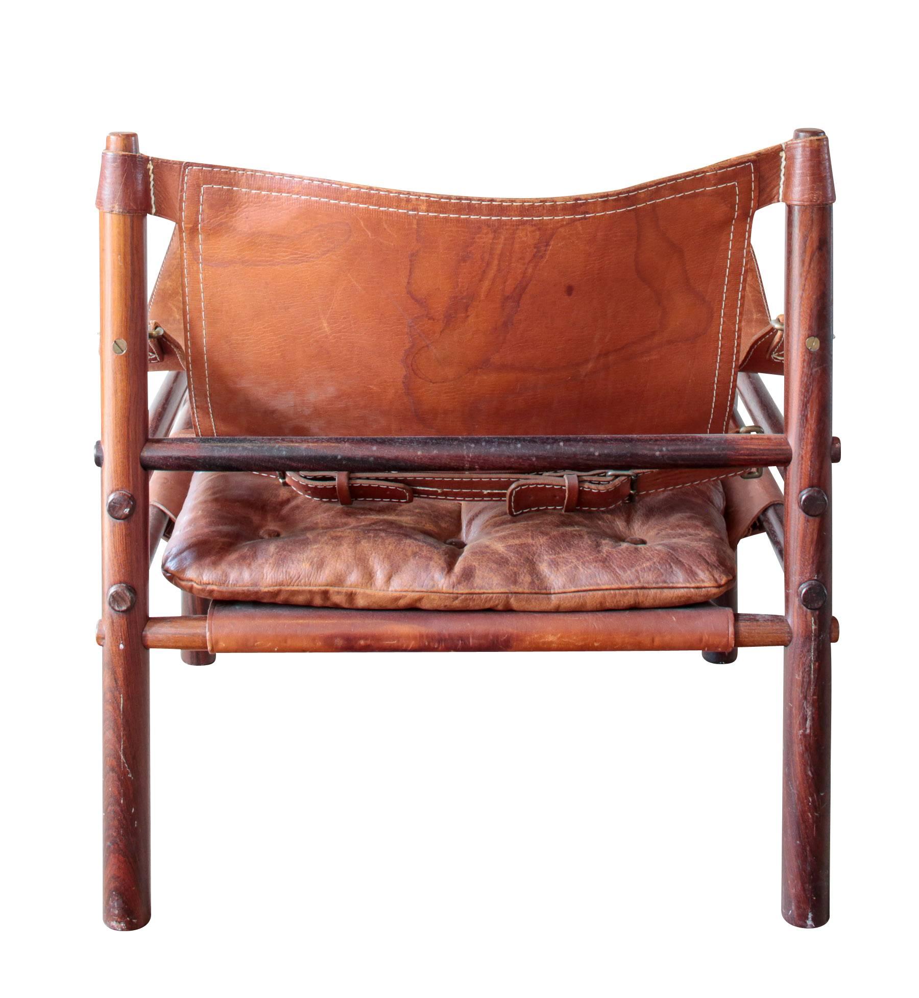 Inspired by Kaare Klint's iconic Safari chair, Arne Norell created the Sirroco Safari chair in 1964. This chair is lightweight and collapsible. It is held together by leather support straps and accentuated with buckles in the back.