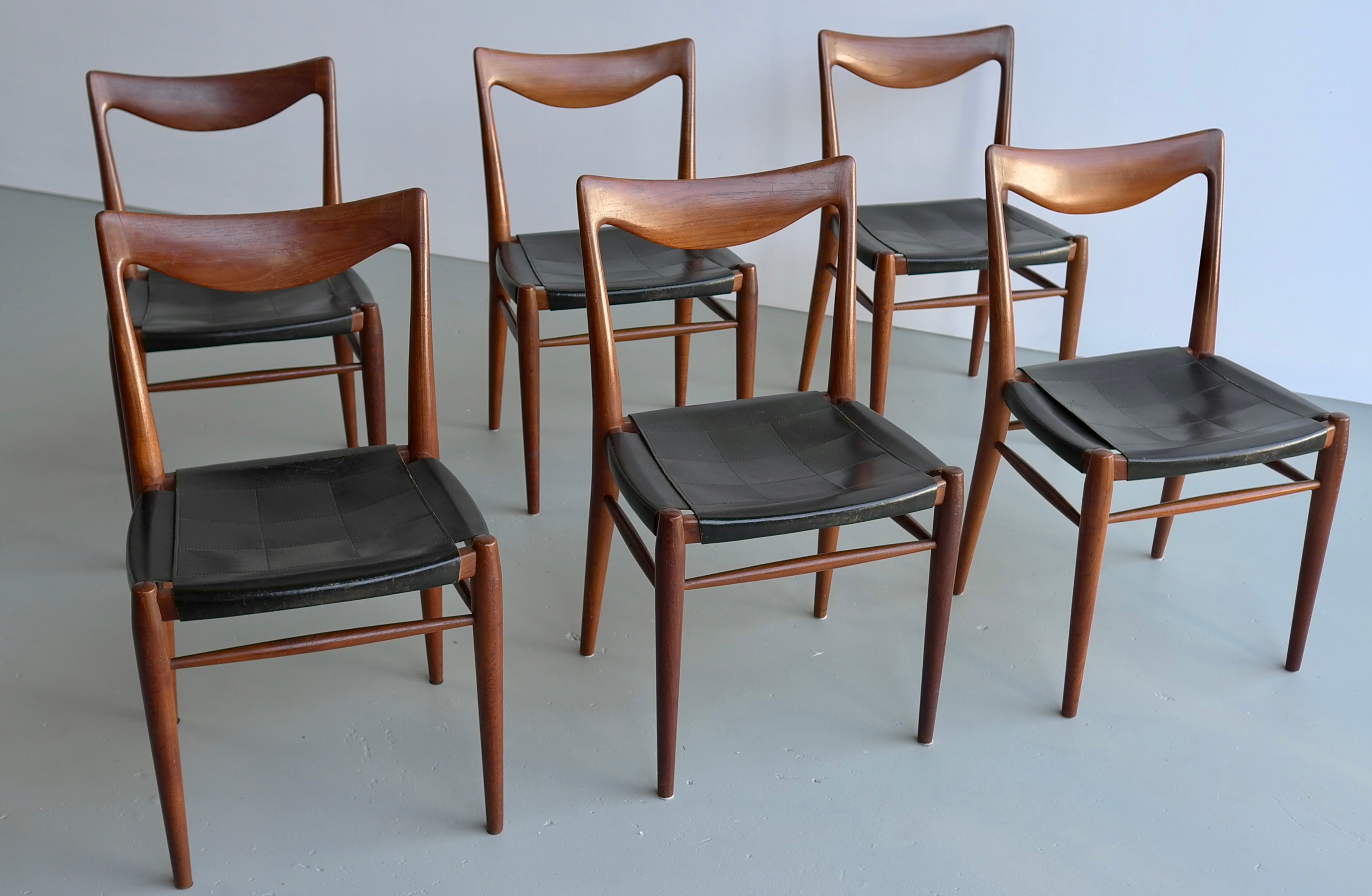 Rastad and Relling six Bambi chairs in teak and leather, Gustav Bahus, 1960s.
These chairs have their original sling black leather seatings.