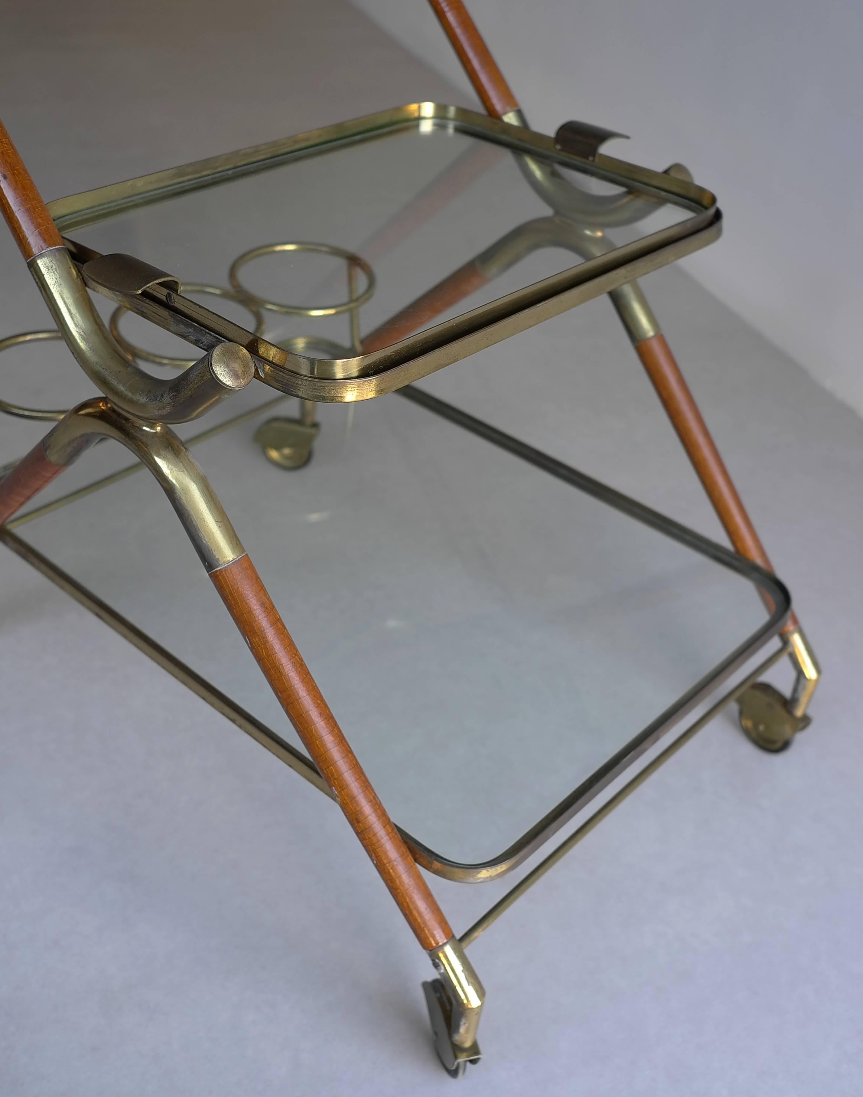 Cesare Lacca Bar Cart, Italy 1950's. Mahogany wood with brass details.
Including bottle holders and detachable tray.