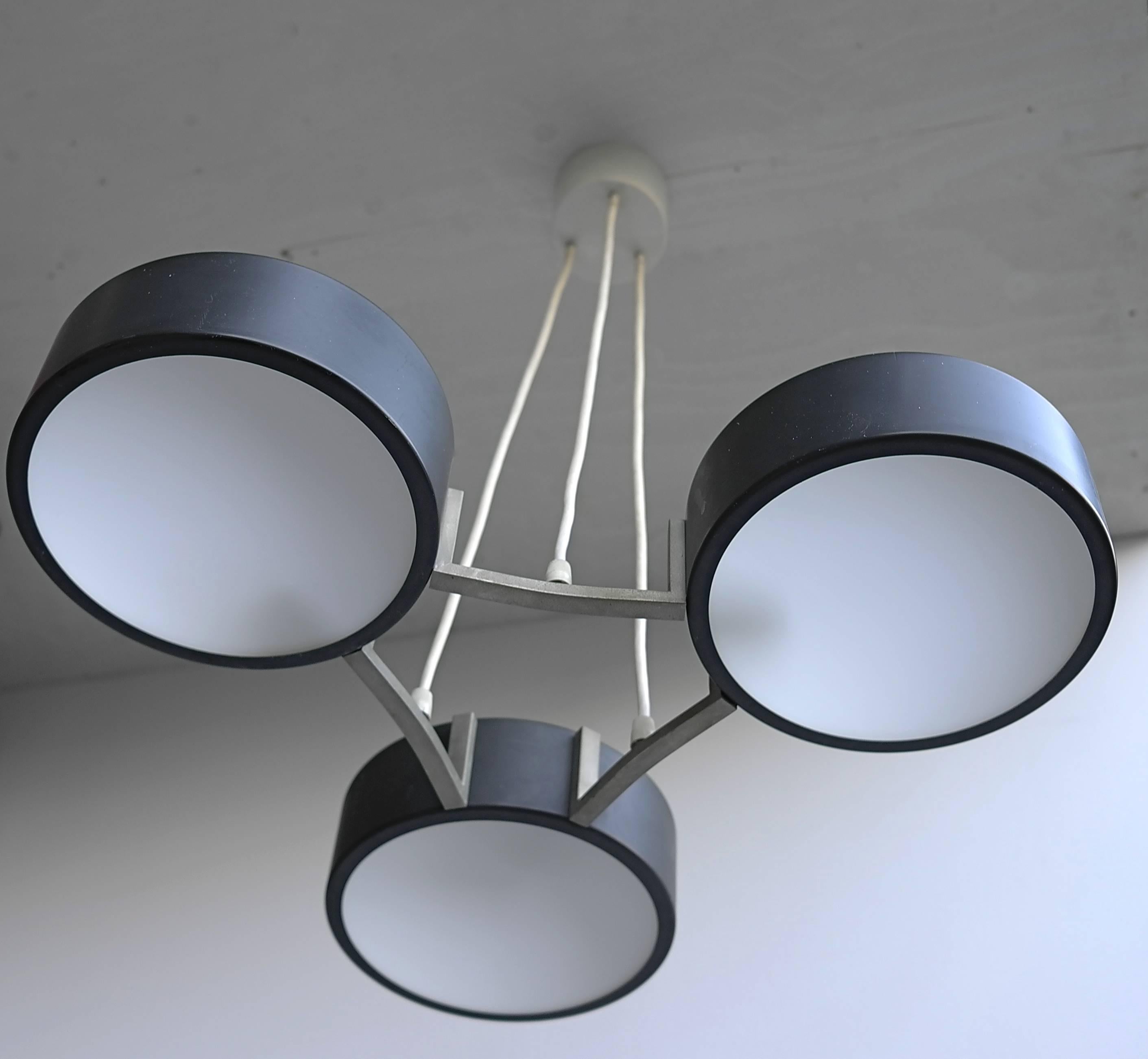 Stilnovo chandelier by Bruno Gatta. Three metal shades with opaline glass.

Measures: Height 56cm (adjustable), diameter 51cm, each shade 20cm.