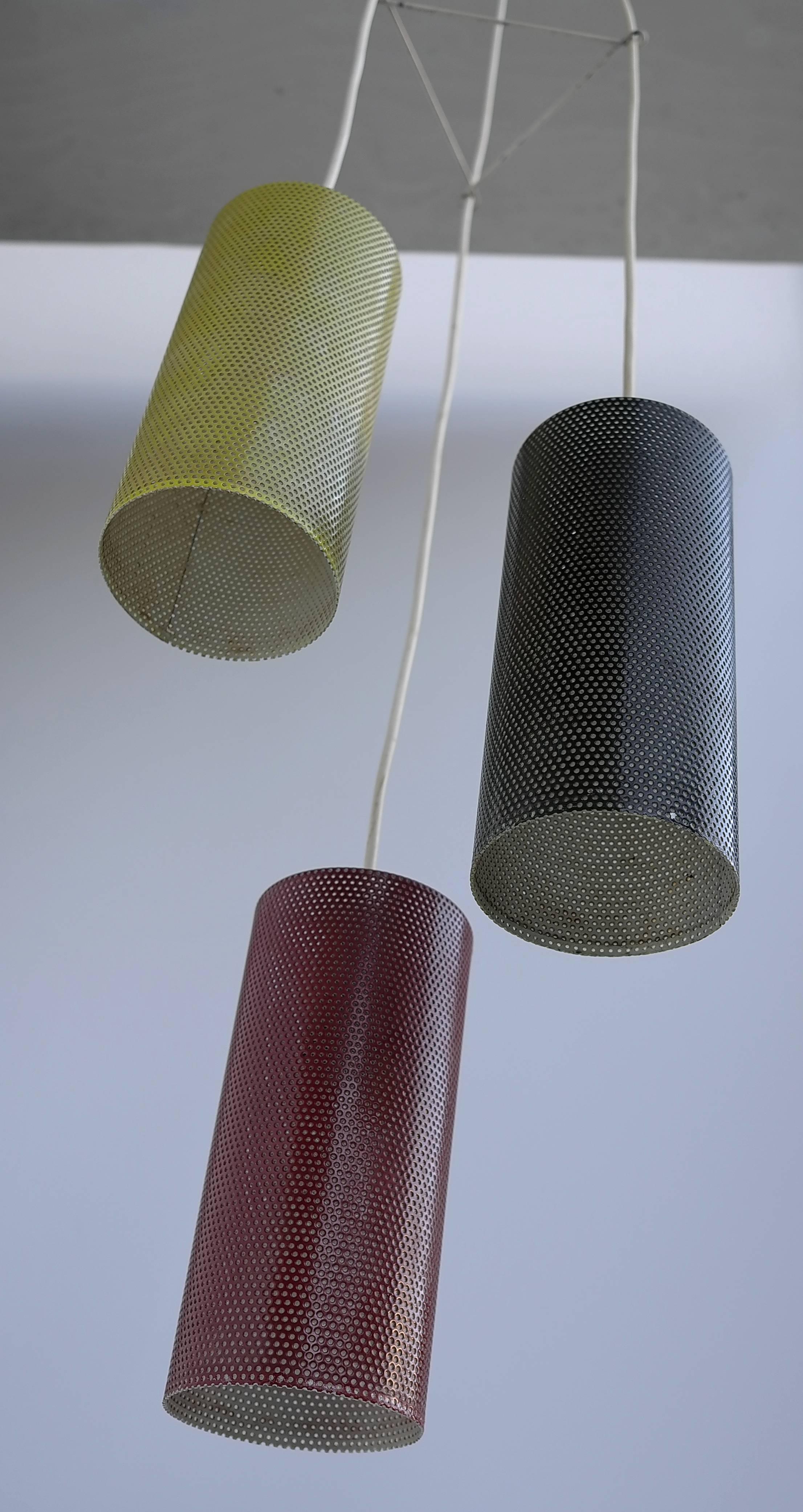 Colored metal pendant in style of Mathieu Matégot. Yellow, black and red metal perforated shades.

Measures: Height 133cm (adjustable) width 30 x 30cm, each shade: 23cm height, 10cm diameter.