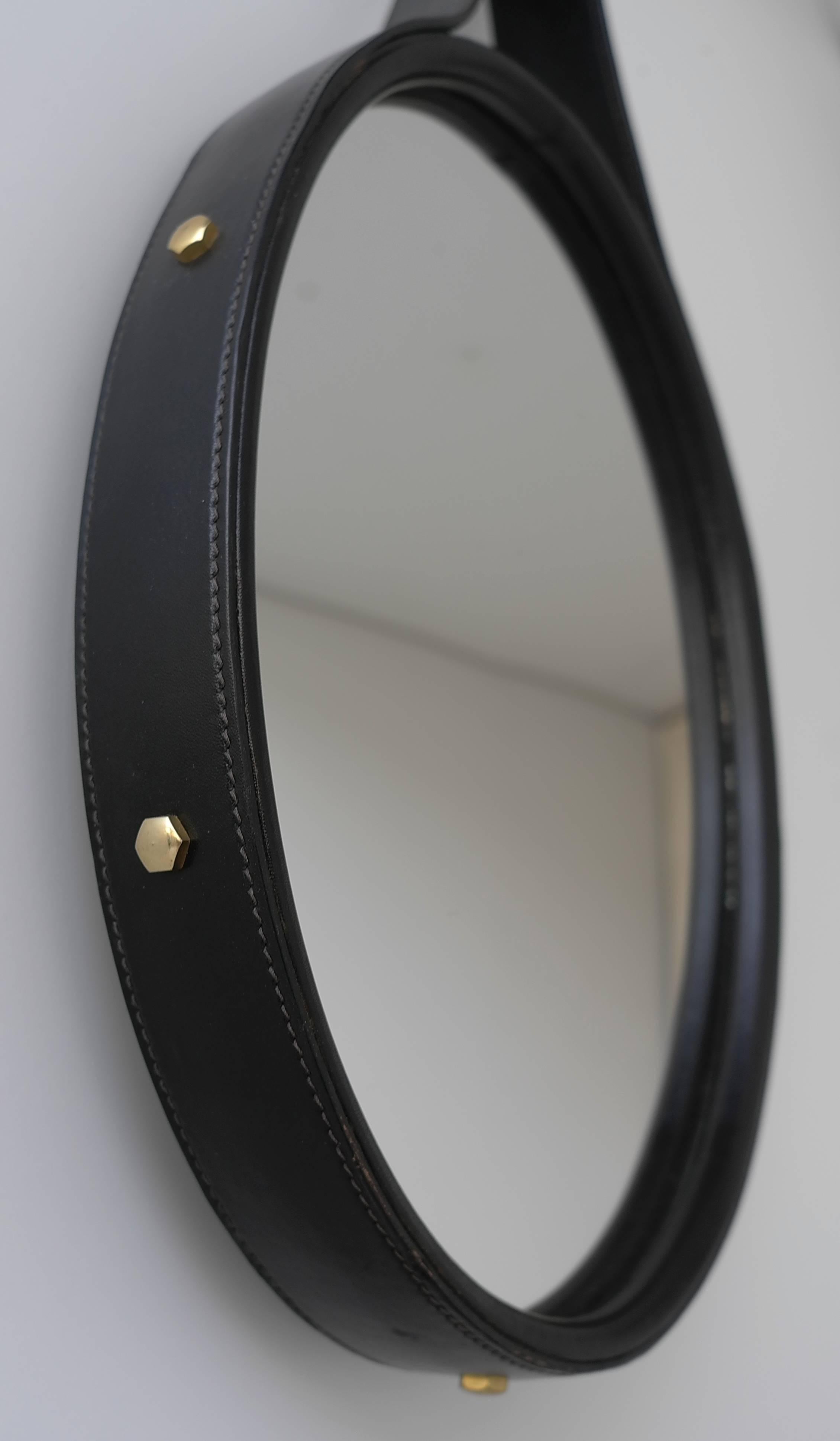 Hand-stitched black leather oval mirror, France, 1960s.
