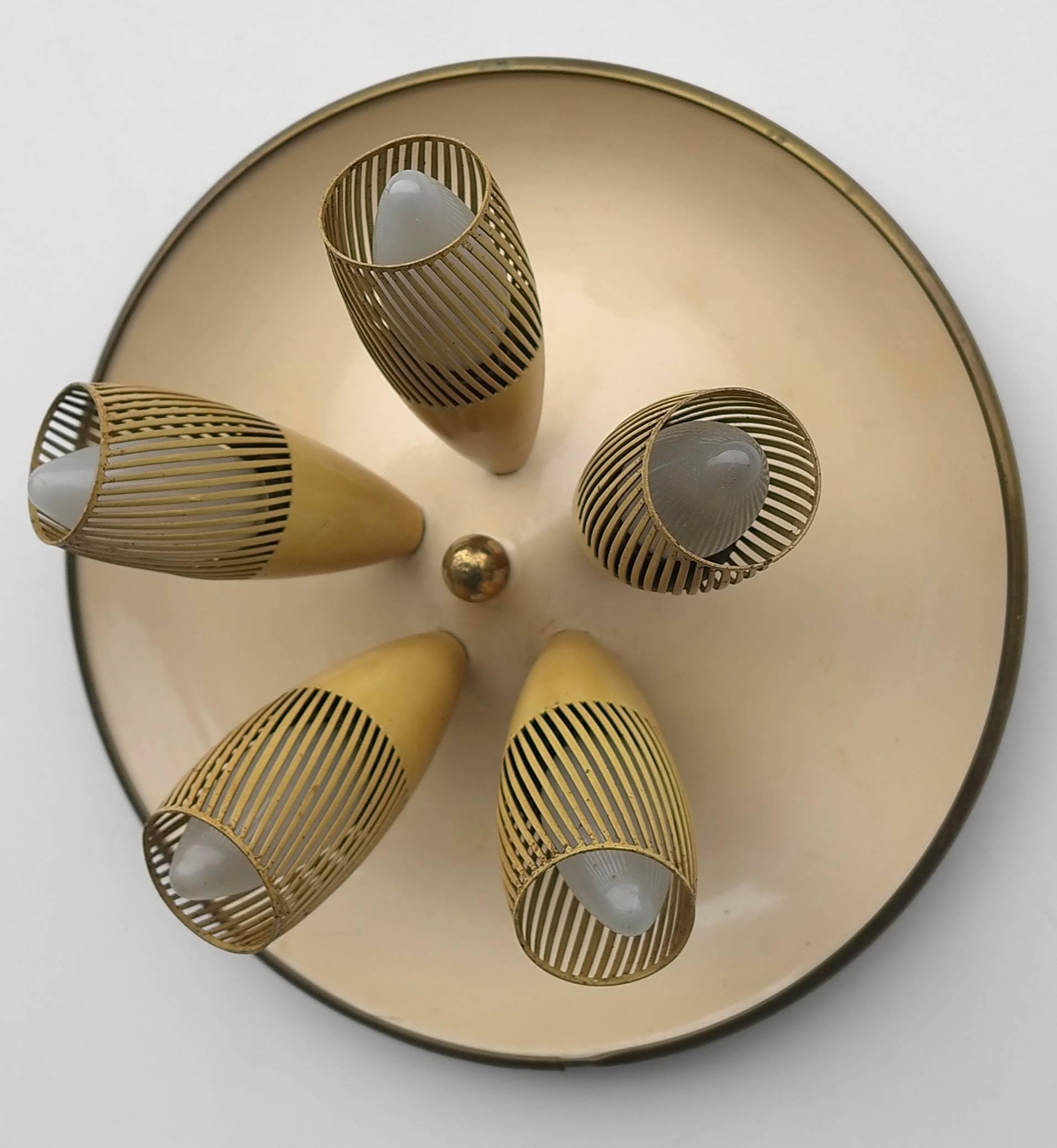 Italian yellow disk wall lamp 1950s with five metal perforated shades.

This lamp can also be used on the ceiling as a flush mount.