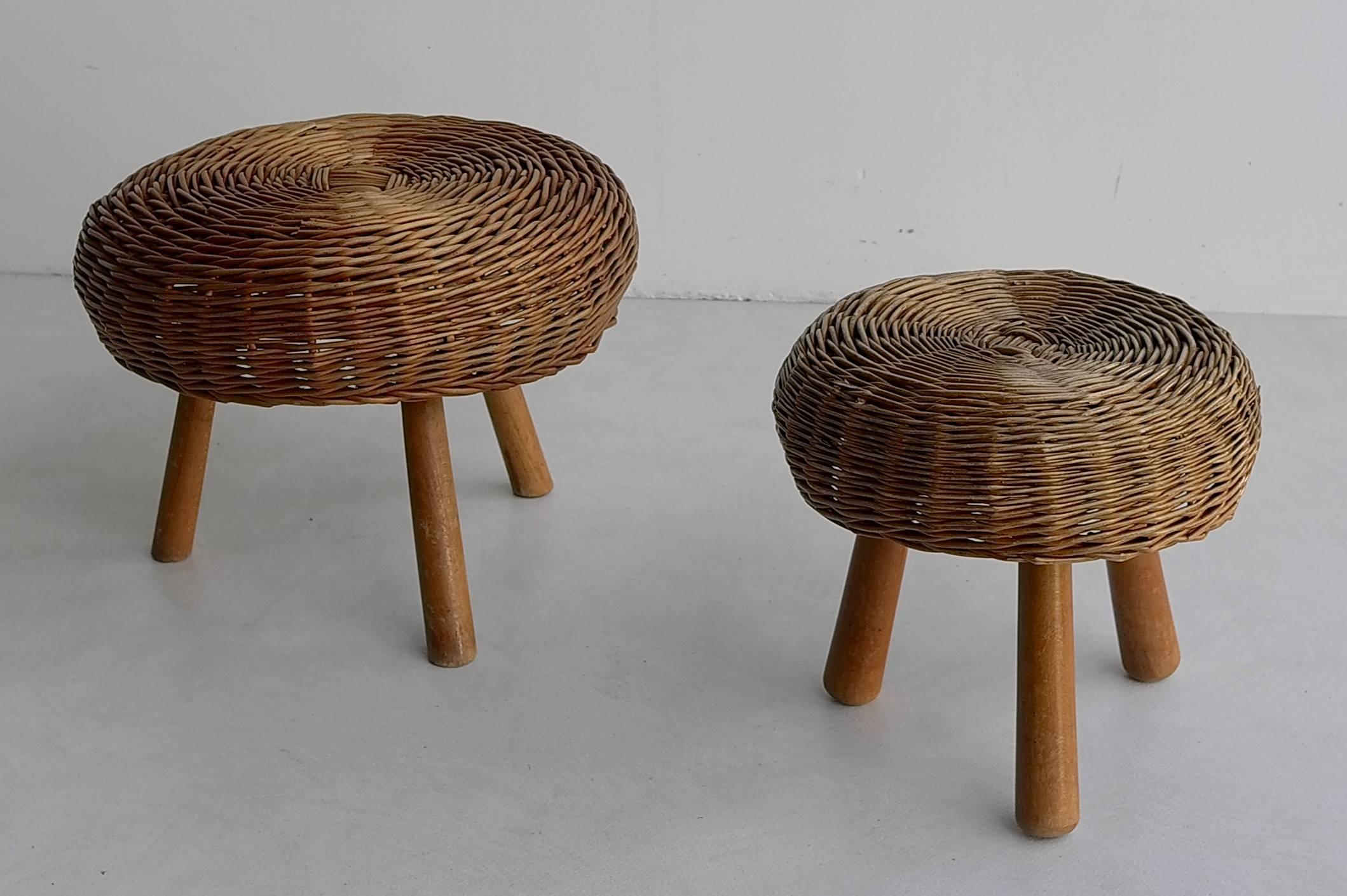 French Wicker stools in style of Charlotte Perriand.

In two sizes: 
The larger one: Height 30cm, diameter 43.
The smaler: Height 28cm, diameter 30cm.