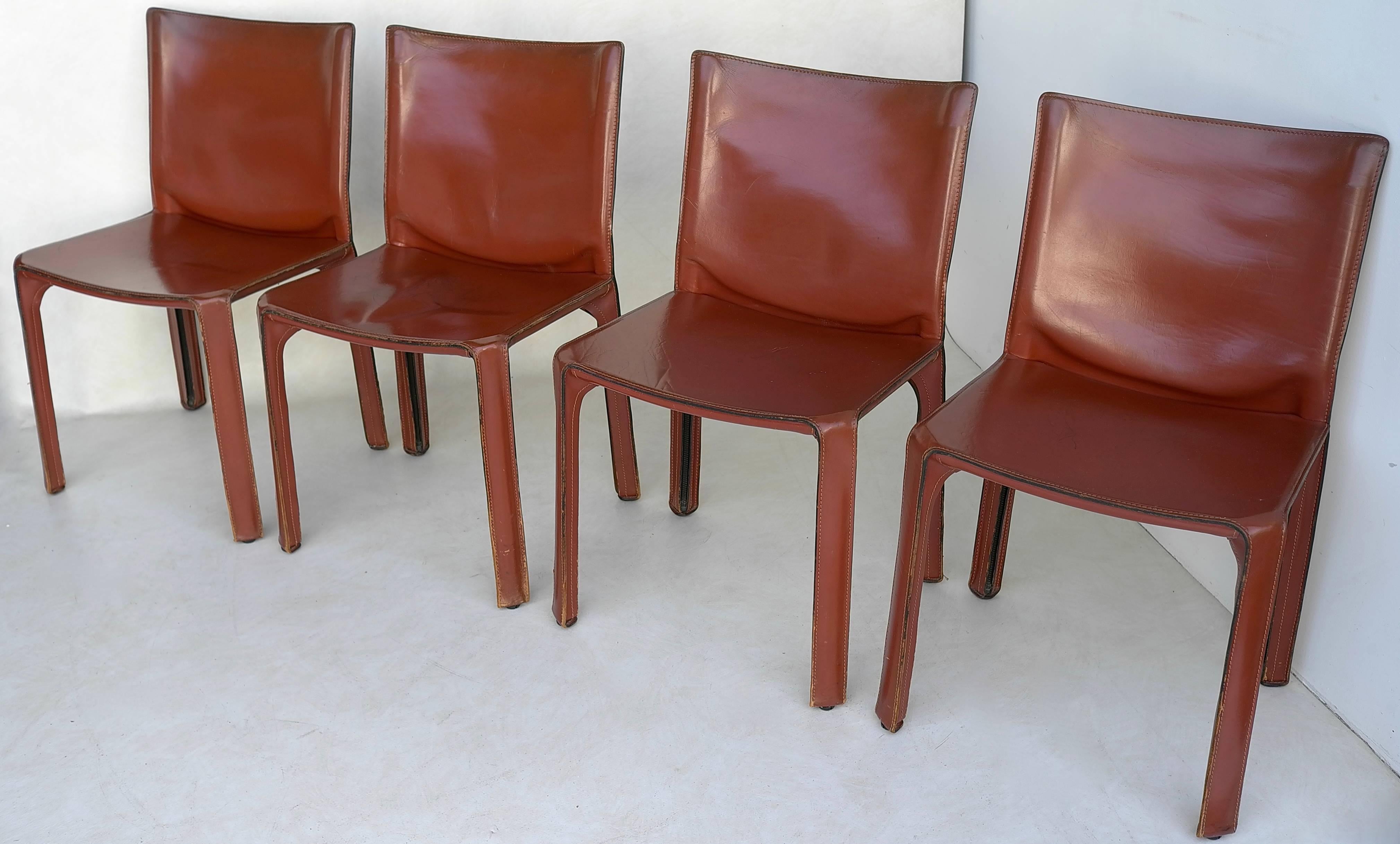 Set of four cab chairs by Mario Bellini for Cassina, Italy, circa 1970s. Wonderful original patina and wear. Broken in like your favorite baseball glove. Signed underneath with Cassina impressed mark on the leather and again on the frame.

Also a