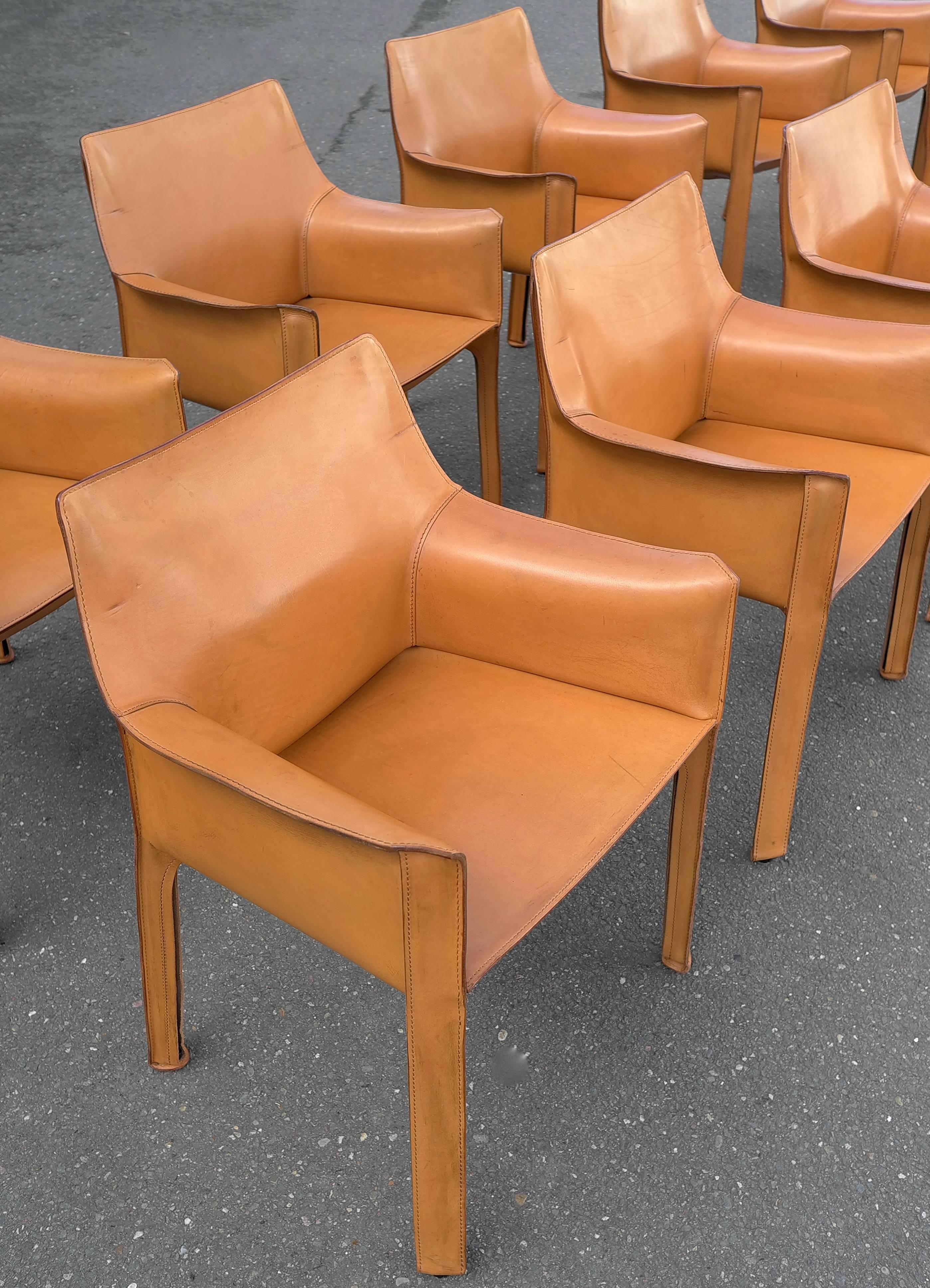 Set of ten cab chairs by Mario Bellini for Cassina in Cognac color Italy, circa 1970s. Wonderful original patina and wear. Broken in like your favorite baseball glove. They have various patina, stains, rubs, scratches and wear. And we wouldn't have