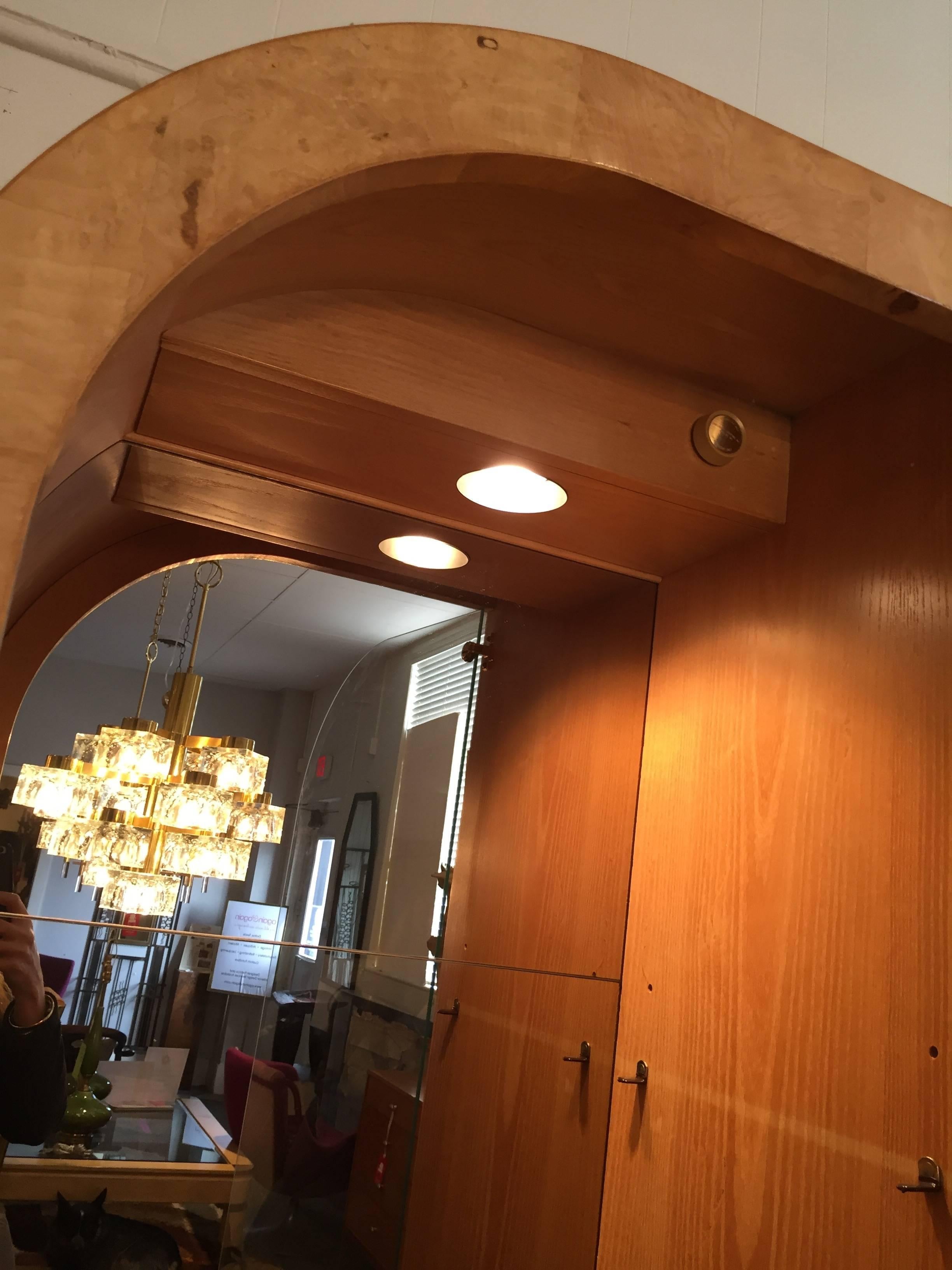 This stylish cabinet with deco flair provides a perfect storage for your collectable items, also having a mirrored interior and dimmable lighting. While also casting a beautiful glow throughout the room for special effect at night, circa 1970s.
