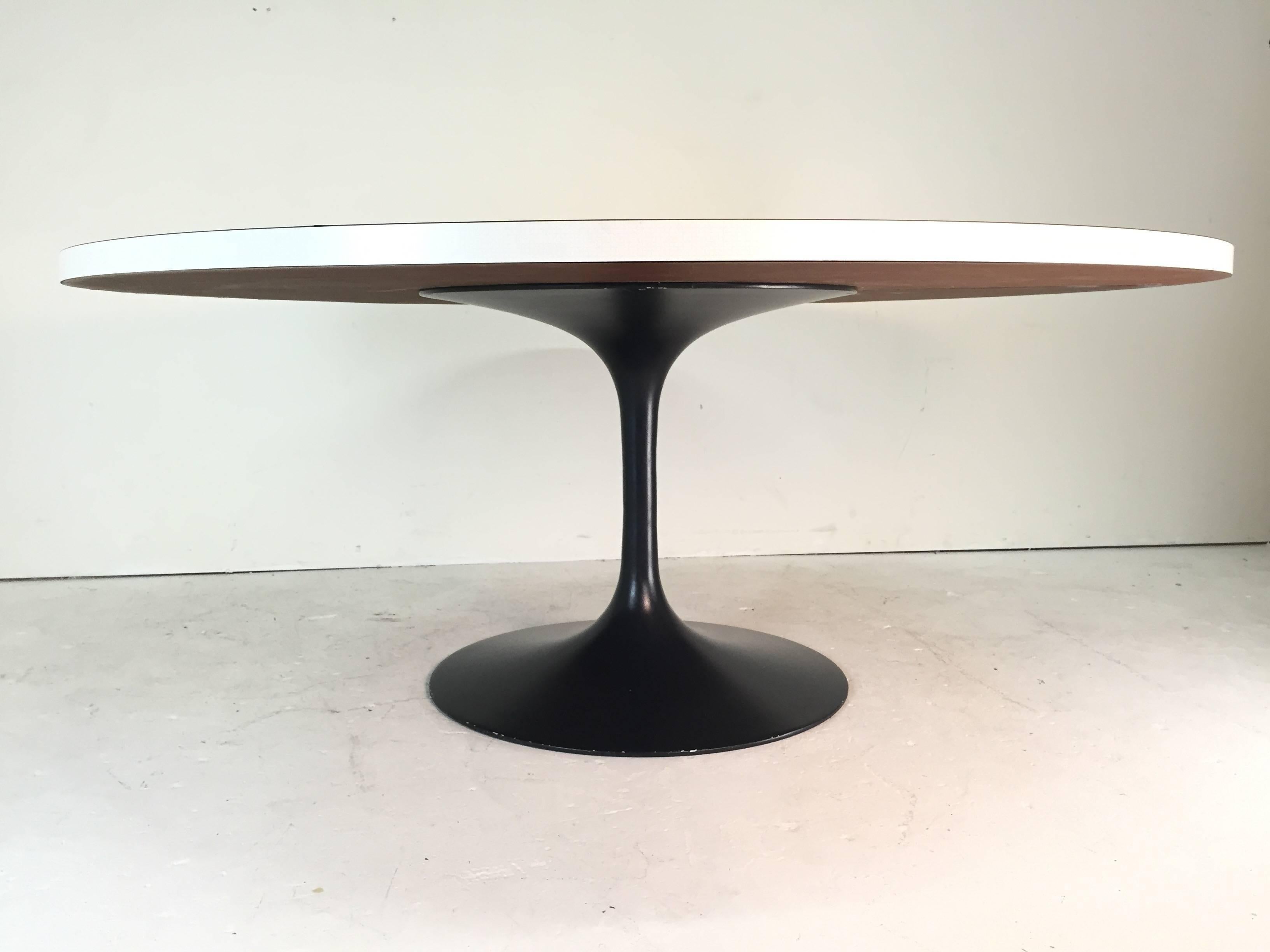 Very large tulip style dining table, the chairs that are shown around the table are available in another listing. We suggest replacing the top with either a new stone or wood top

Base diameter: 
- 30