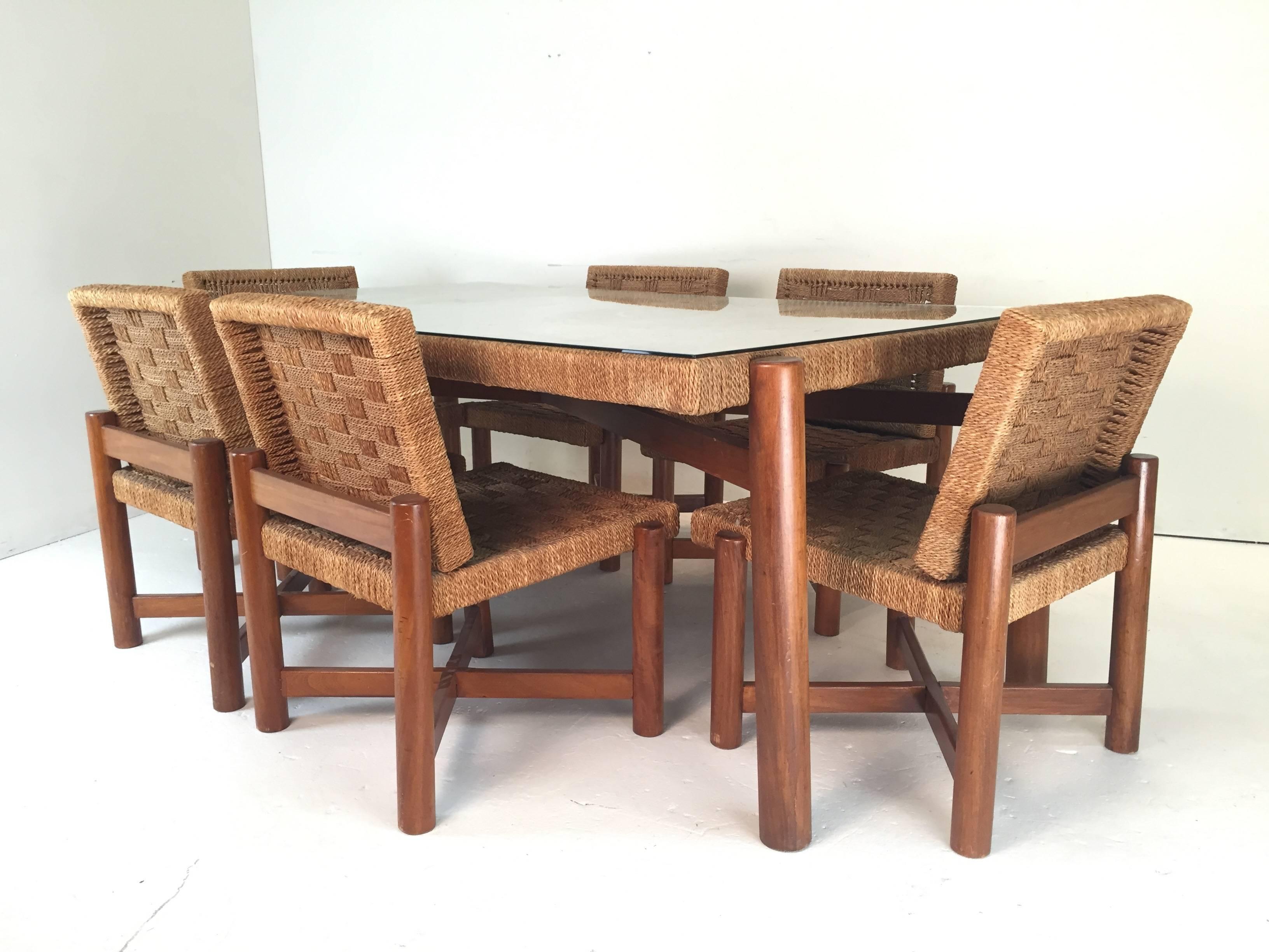 In good original condition with minor wear consistent with age and use. The frames of the table and chairs are built of ash wood with a woven sisal rope covering. These would perfectly match in as interior with the designs from Charlotte Perriand,