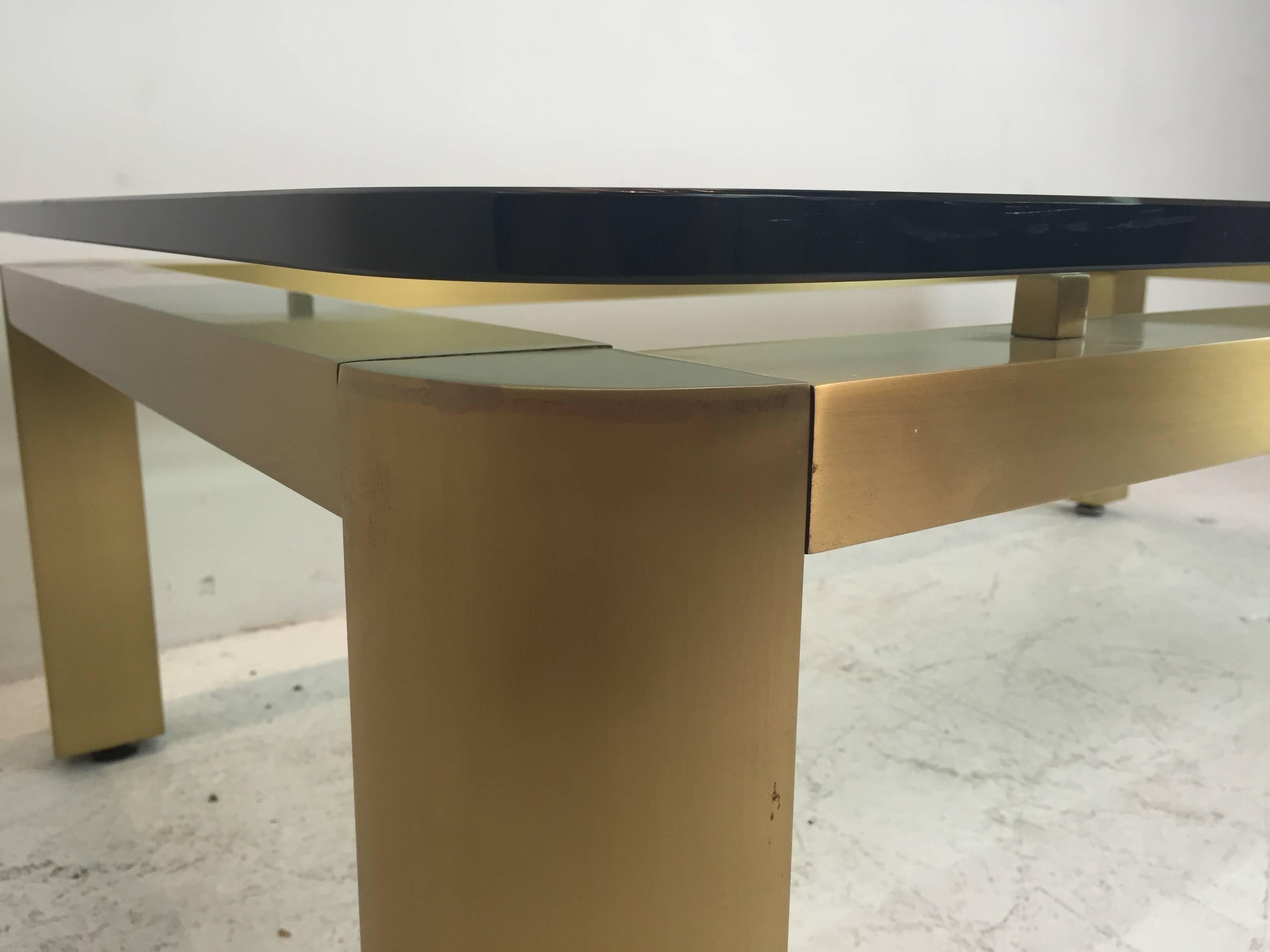 A stylish 1970s brushed brass coffee table with floating glass top. The brass has a wonderful shimmer effect. The table has been well cared for from it's original owner and in excellent vintage condition.