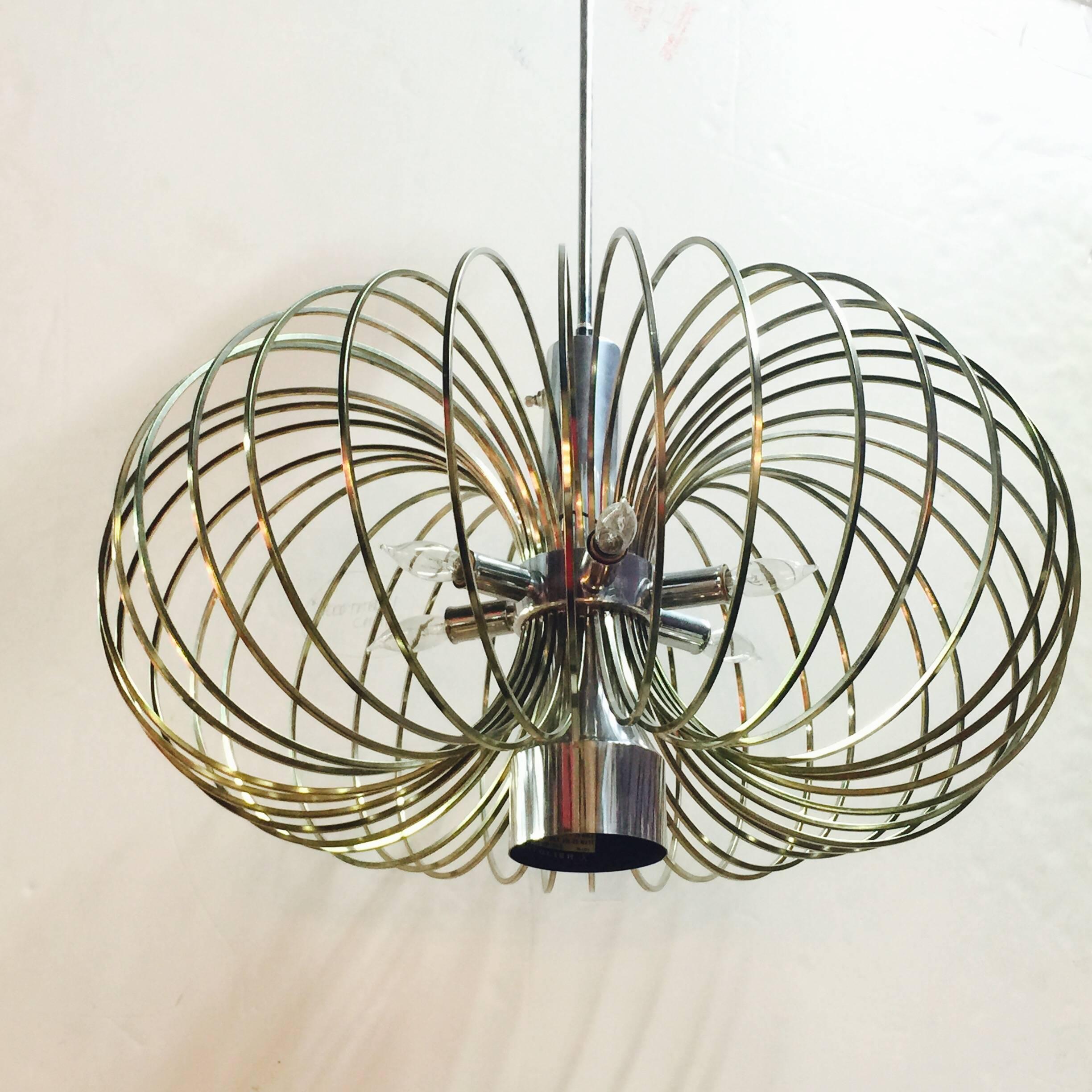 This stunning chandelier is composed of nickel and brass accents. Six light with one down light by Sciolari.

Dimensions: 22"diameter x 13"t with a 13" rod.