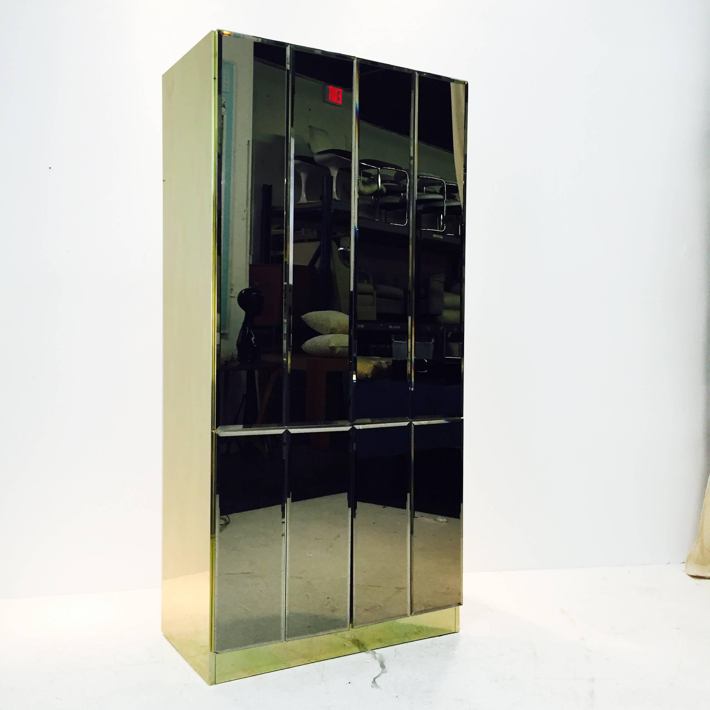 Tall bronzed mirror and brass cabinet by Ello.

dimensions: 36.5
