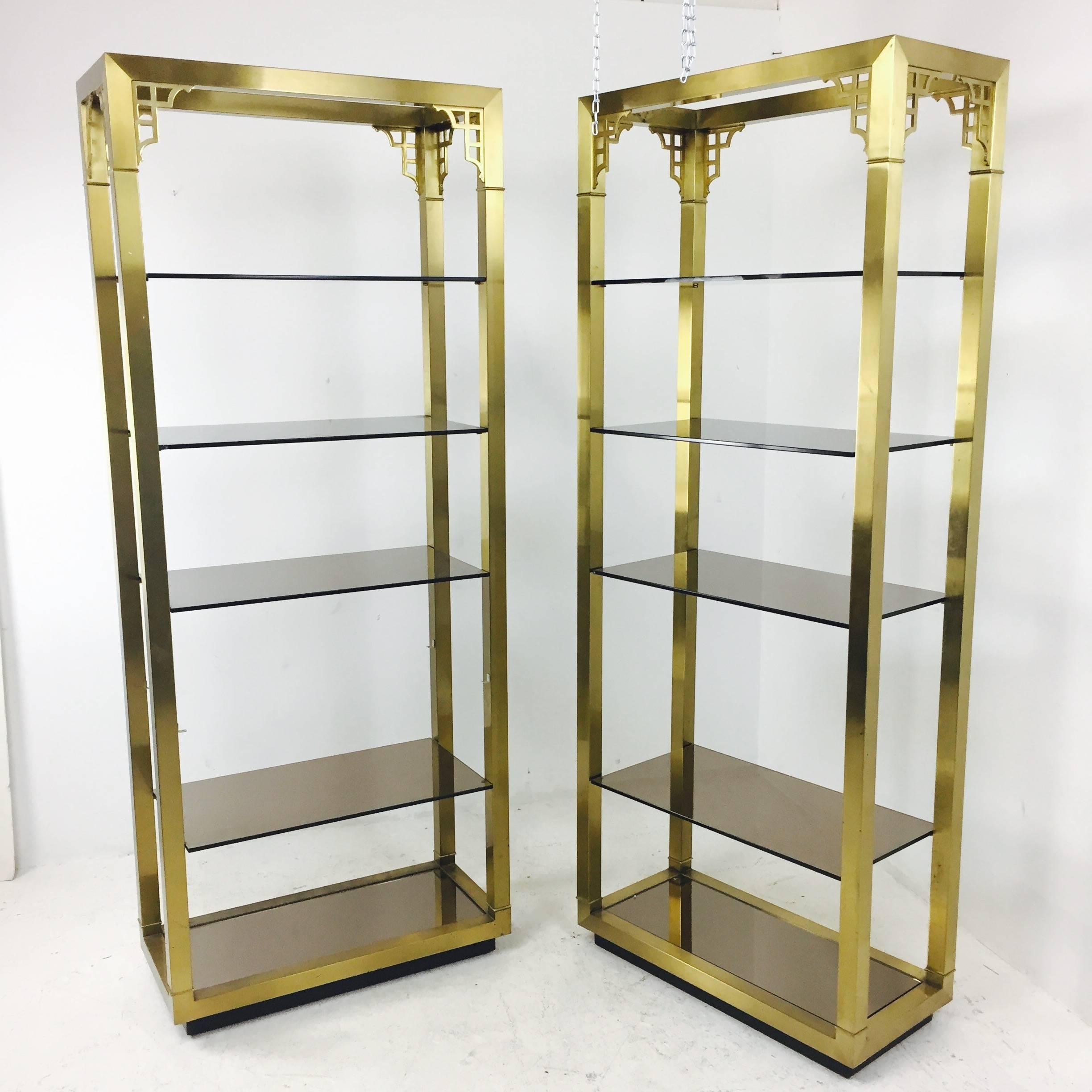 Pair of brass Greek key etageres with glass shelving. There is wear on brass finish. There is some chipping on the edges of the glass.

Dimensions: 32" W x 15" D x 80" T.


 