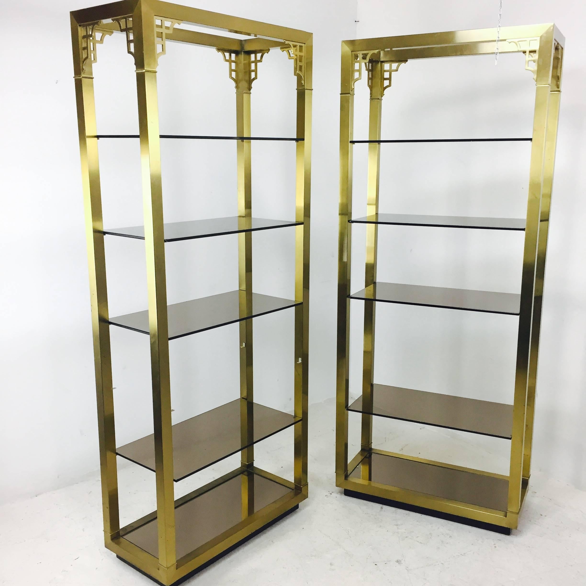 Pair of Brass Greek Key Etageres with Smoke Glass Shelving In Good Condition In Dallas, TX