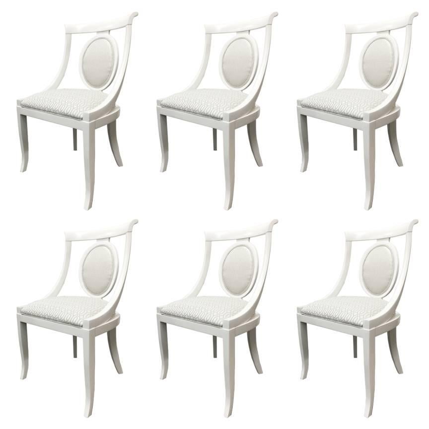 Set of 6 lacquer dining chairs. Newly lacquered in a satin white and upholstered shimmery metallic fabric.

Dimensions: 22