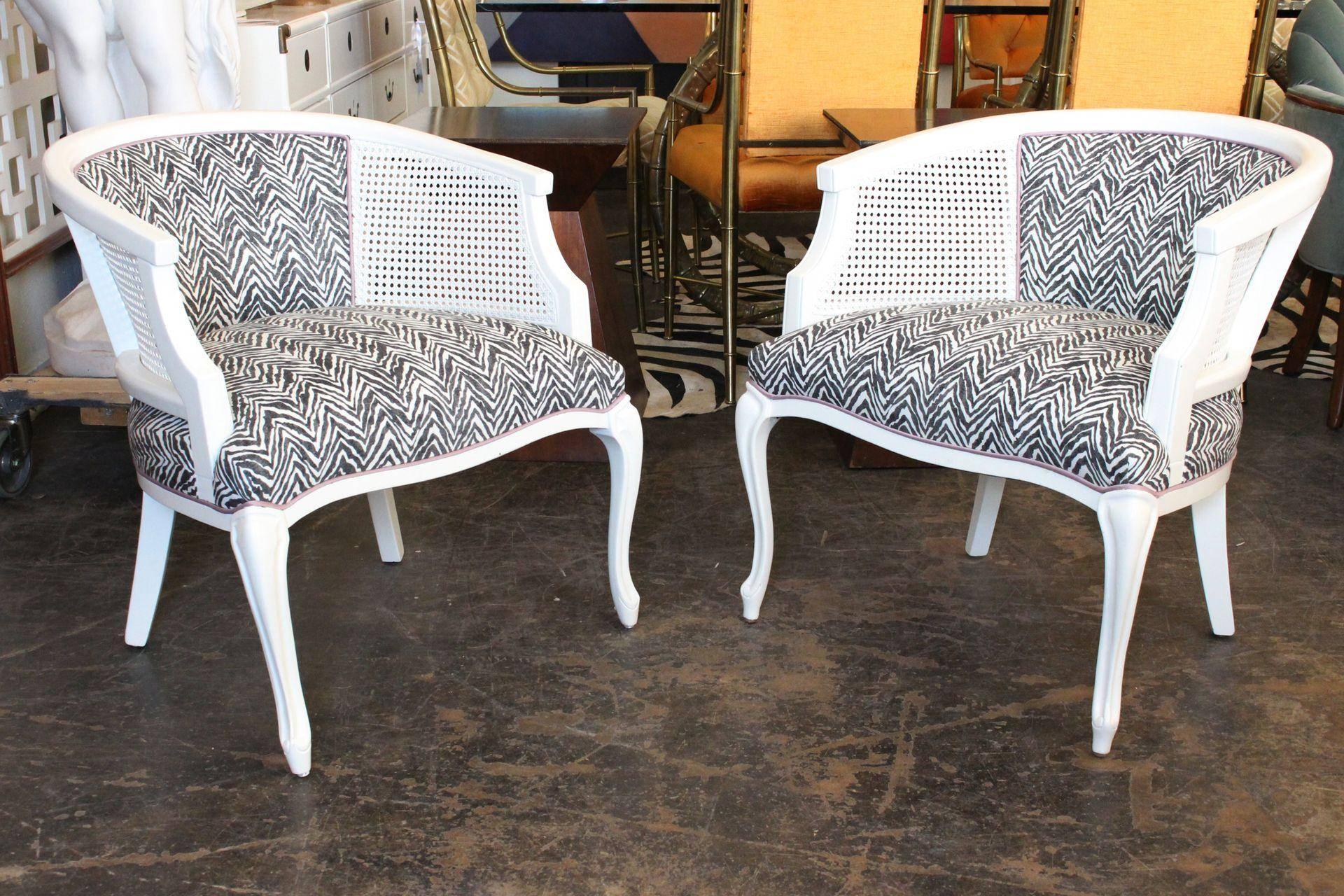 Pair of newly lacquered and upholstered cane barrel chairs. Upholstered in fun zebra fabric with lilac cording with the lilac fabric on back.

Dimensions: 25.5