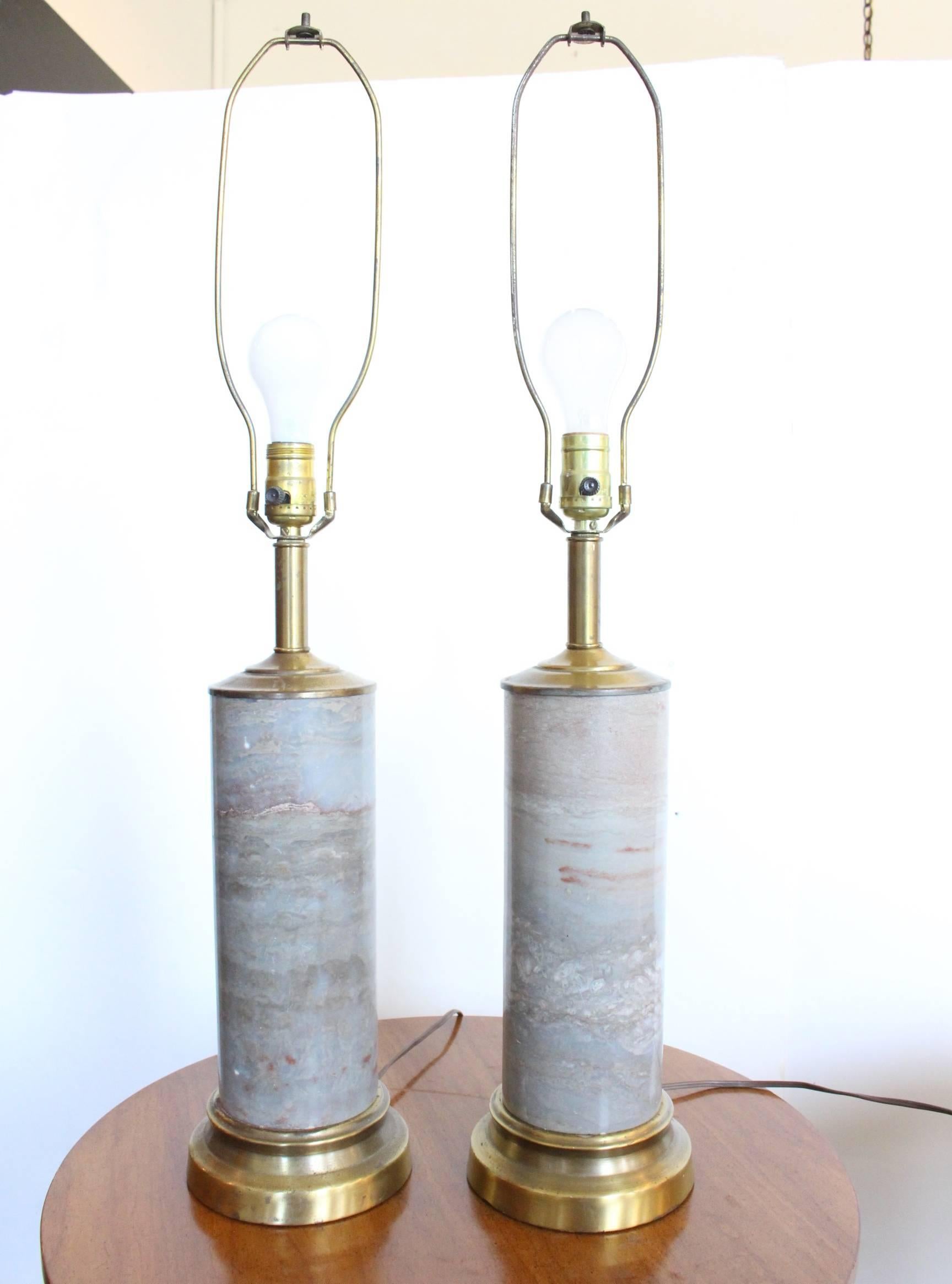 Pair of marble lamps with brass accents.

Dimensions: 6" diameter x 20" (to socket).