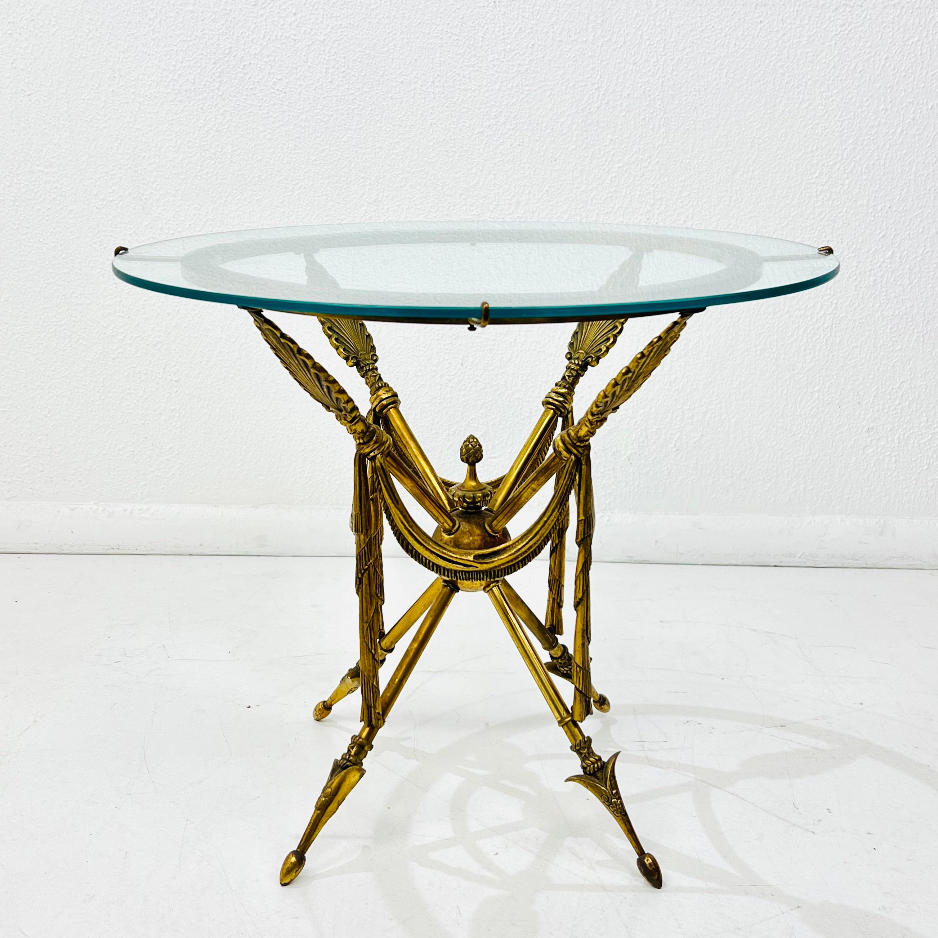 Glass top Gueridon bronze arrow base side table, attributed to Maison Jansen.