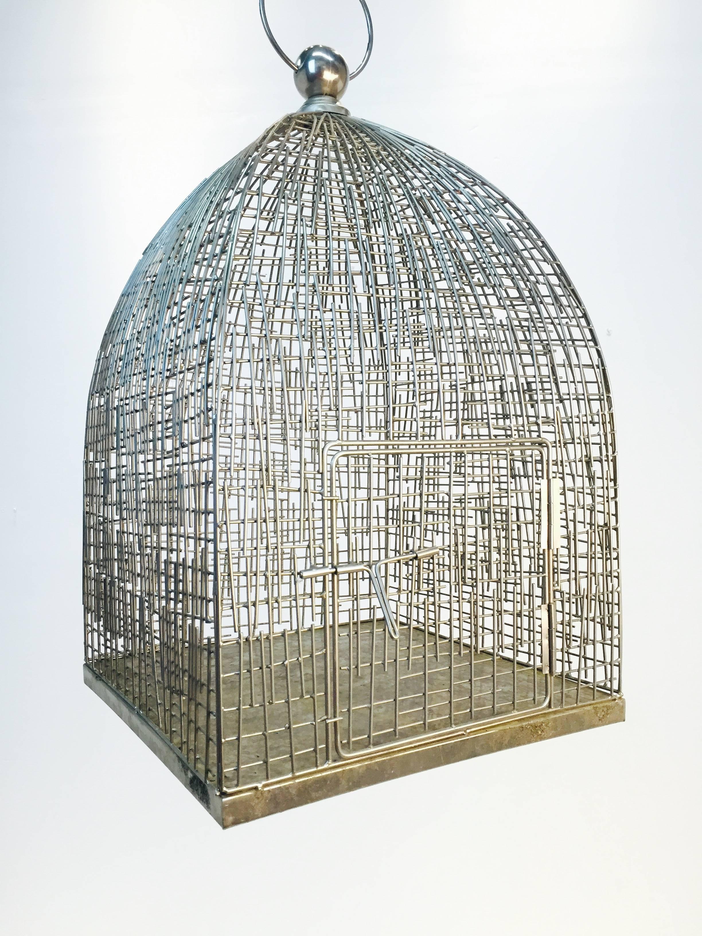 Large and elaborate metal bird cage, very sculptural.