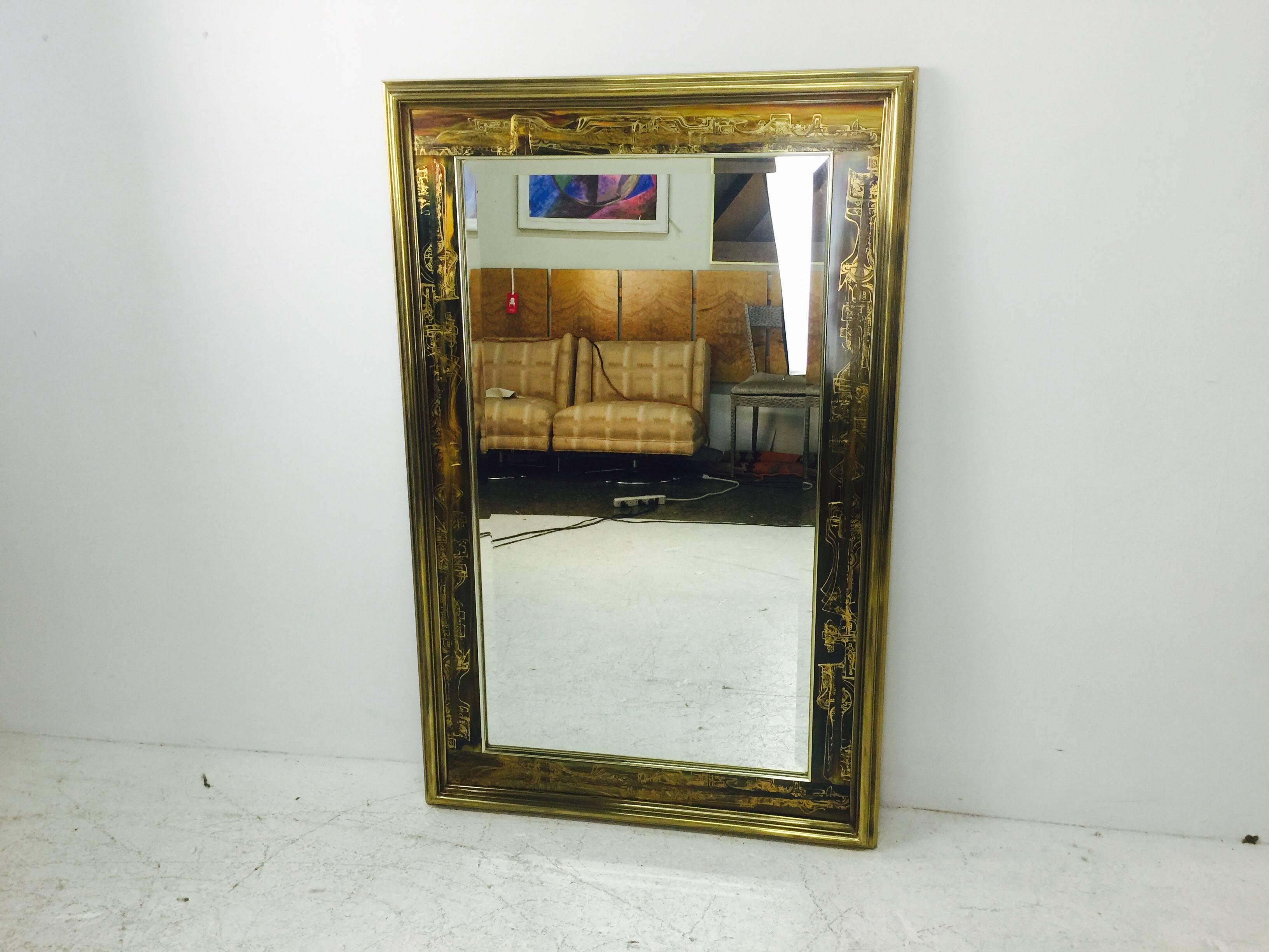 Stunning beveled mirror by Bernhard Rohne for Mastercraft featuring his iconic acid-etched brass panels. Mirror can be positioned vertically or horizontally. 

Measures: 34
