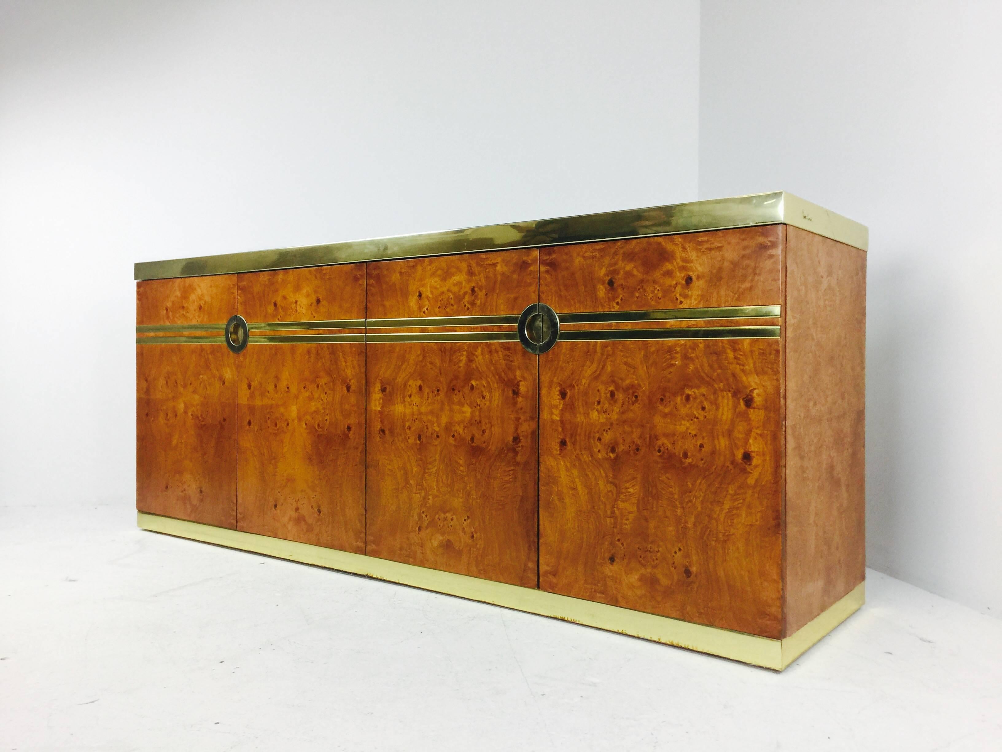 Burl and brass credenza by Pierre Cardin. Does need refinishing,
circa 1970s.

Dimensions: 74" W x 19" D x 30.25" T.