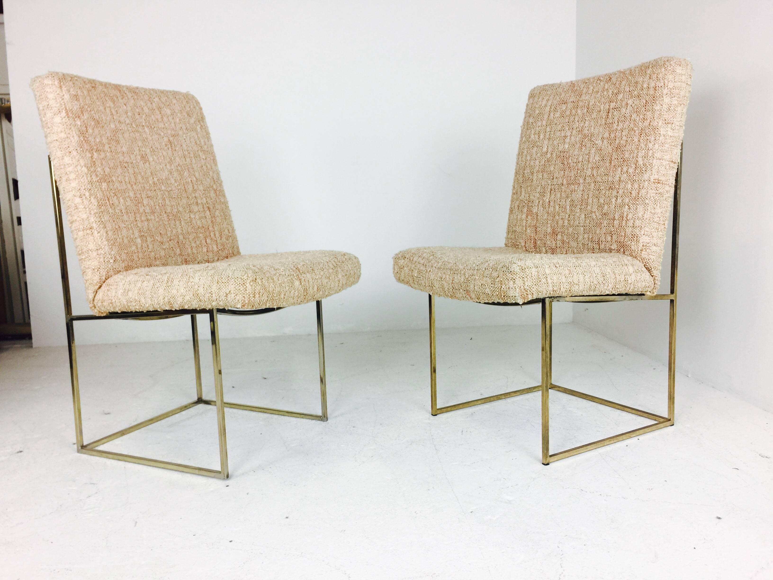 Pair of Milo Baughman brass dining chairs with original textured fabric. Refinishing and upholstery recommended, circa 1970s.

Dimensions: 23" W x 20.5" D x 36" T.
seat height 18".