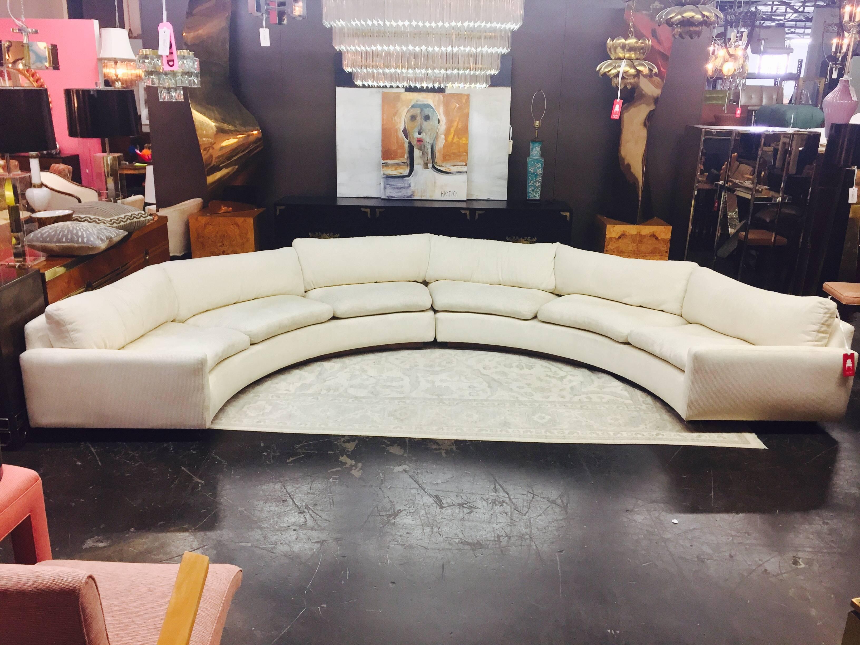 Two-piece. White semicircular sectional sofa by Milo Baughman with wood plinth base. Upholstery is in good vintage condition and needs cleaning.

Dimensions: 159